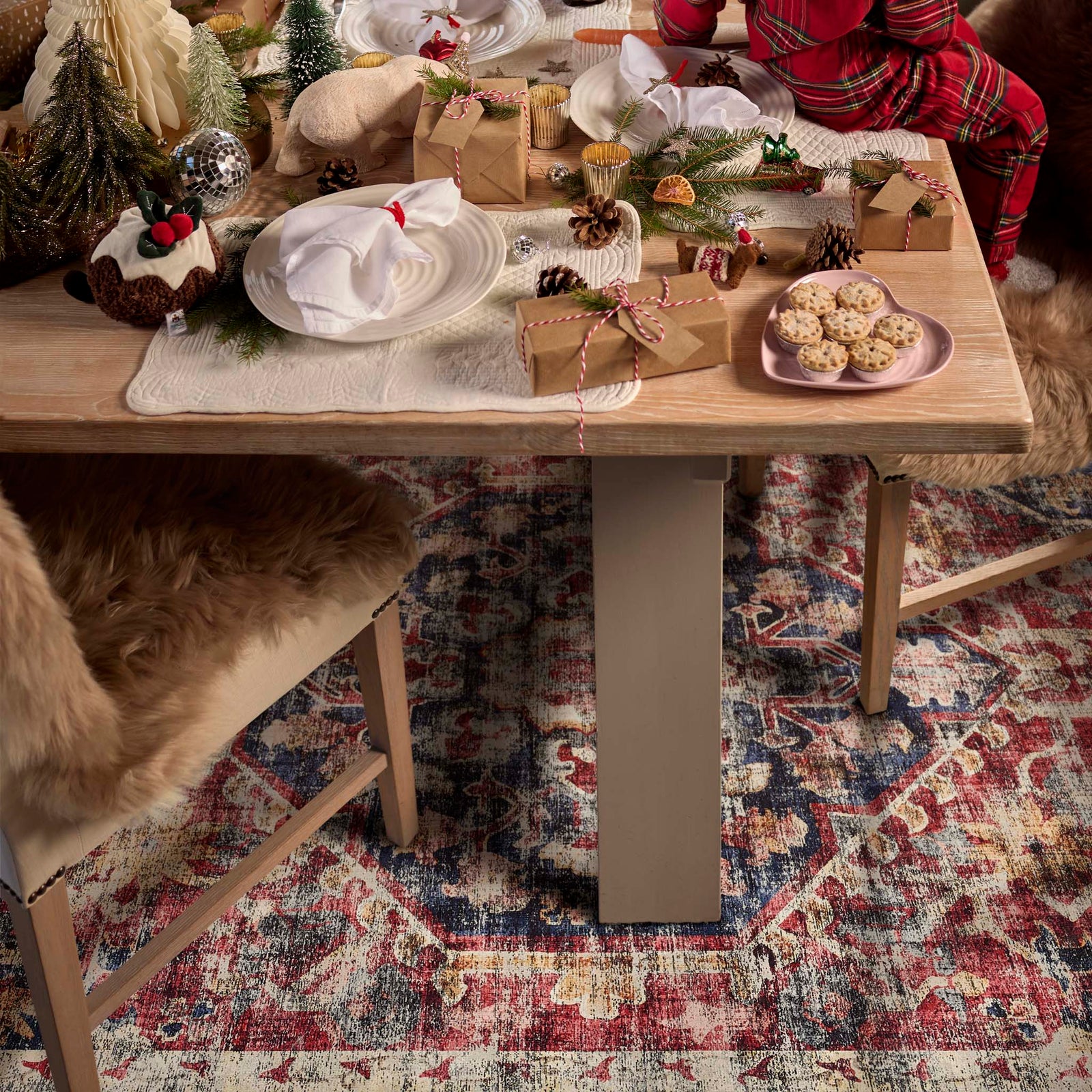 Royal Heritage Eco‑Washable Rug with a vintage pattern, styled under dining room table filled with christmas treats.