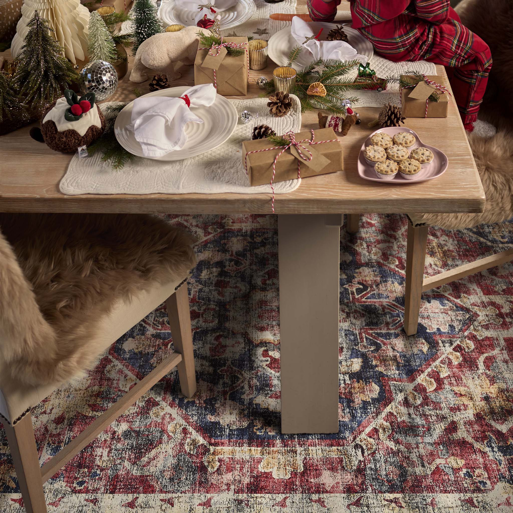 Royal Heritage Eco‑Washable Rug with a vintage pattern, styled under dining room table filled with christmas treats.