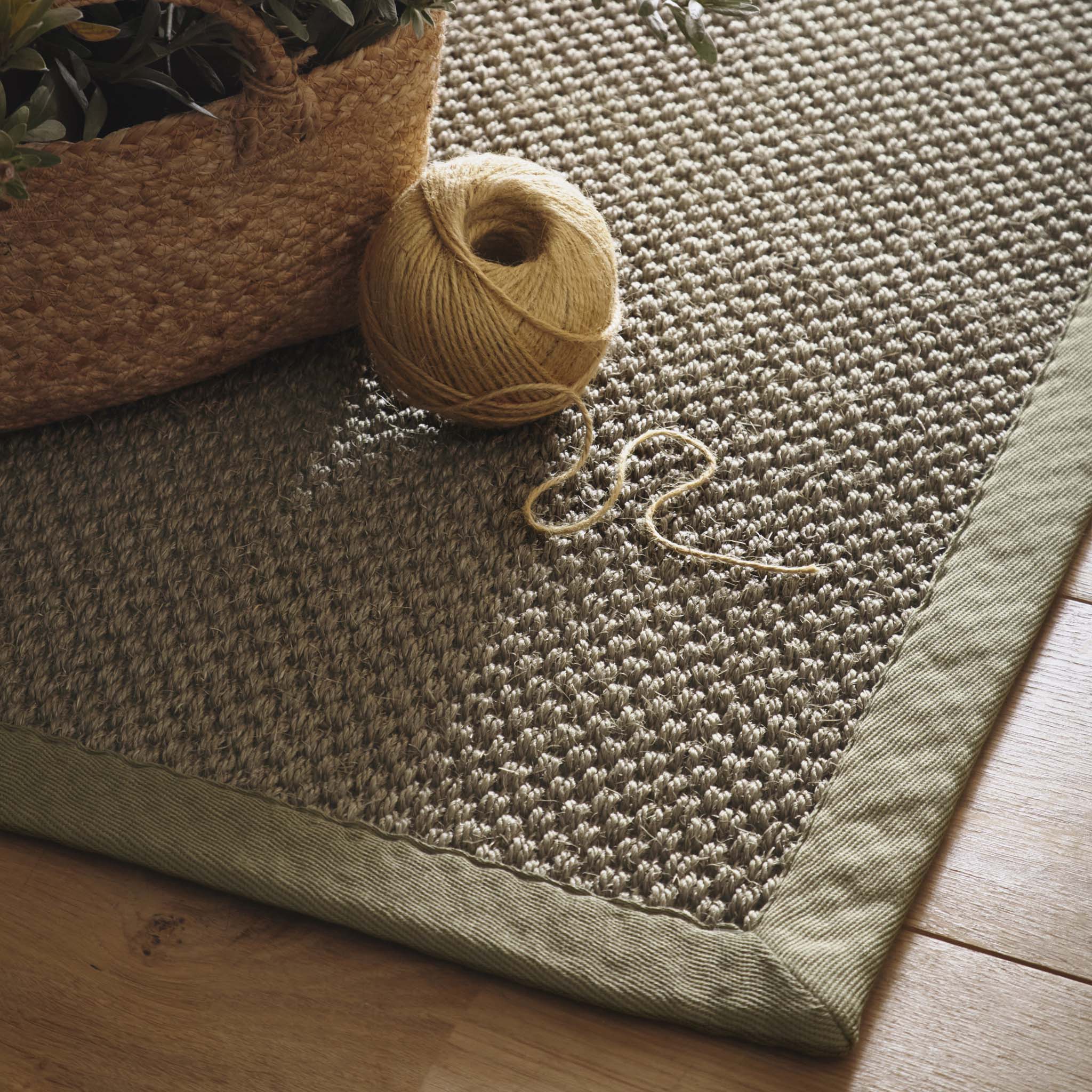 Close-up of Sisal Green with Sage Green Border Runner showing pile height, green border, and a textured centre. 