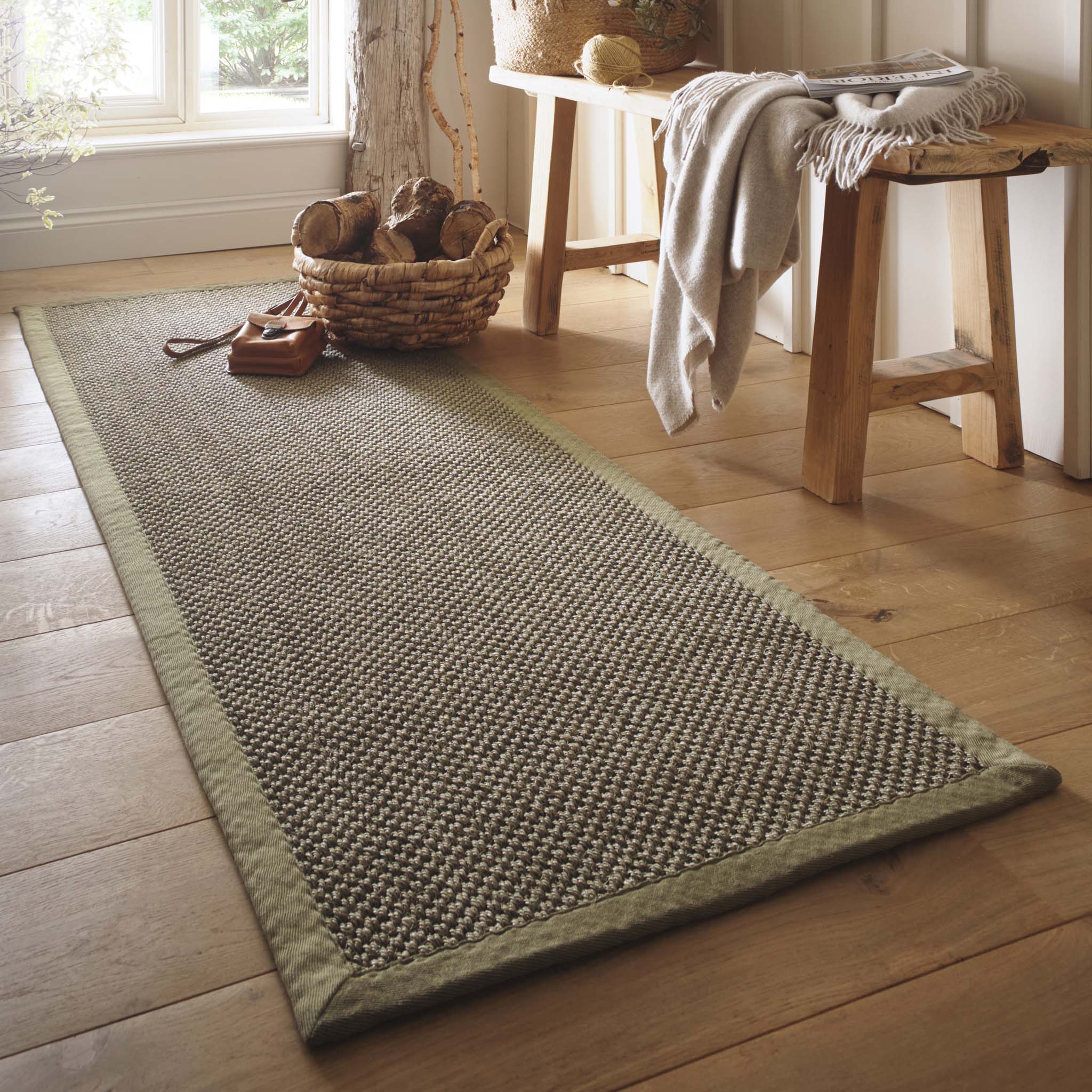 Sisal Green with Sage Green Border Runner with a green border and a green textured centre, styled in front of a window.