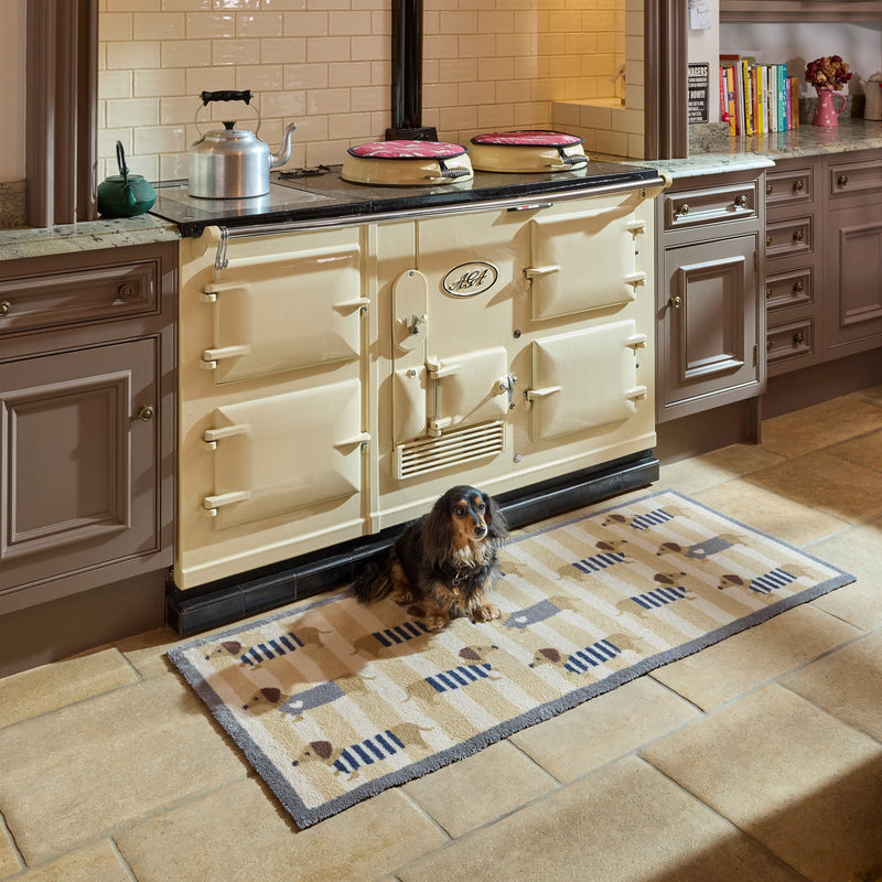 Sausage Dog Chic Washable Runner- 100% recycled cotton runner featuring sausage dogs in jumpers against a beige and cream striped background. 