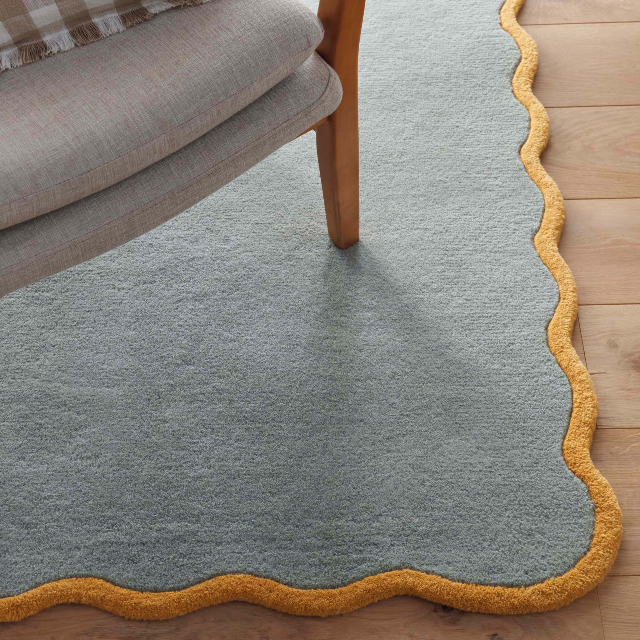 Scalloped Elise Duck Egg Ochre Rug - a 100% wool blue rug featuring a scalloped yellow border. 
