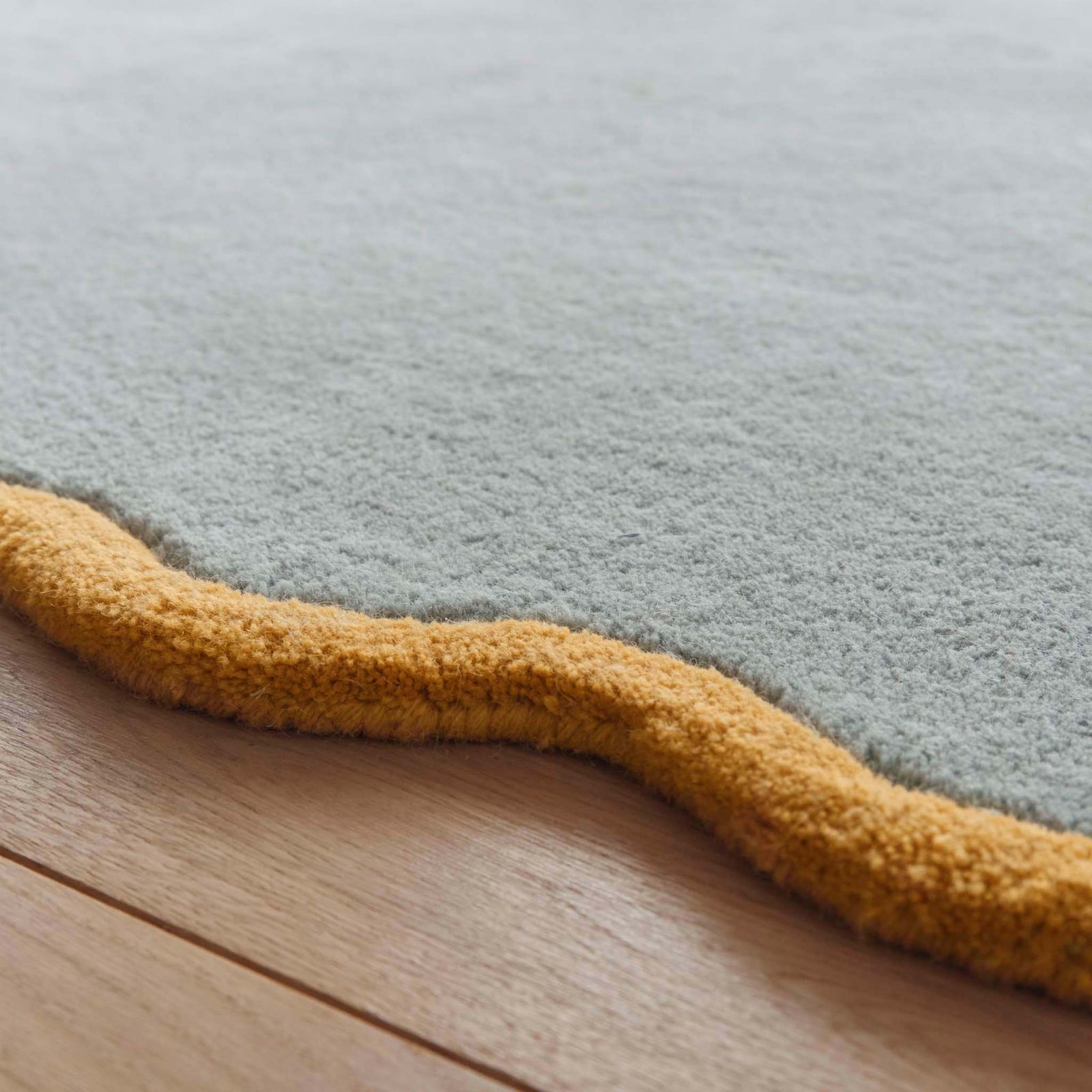 Scalloped Elise Duck Egg Ochre Runner - a 100% wool blue runner featuring a scalloped yellow border. 