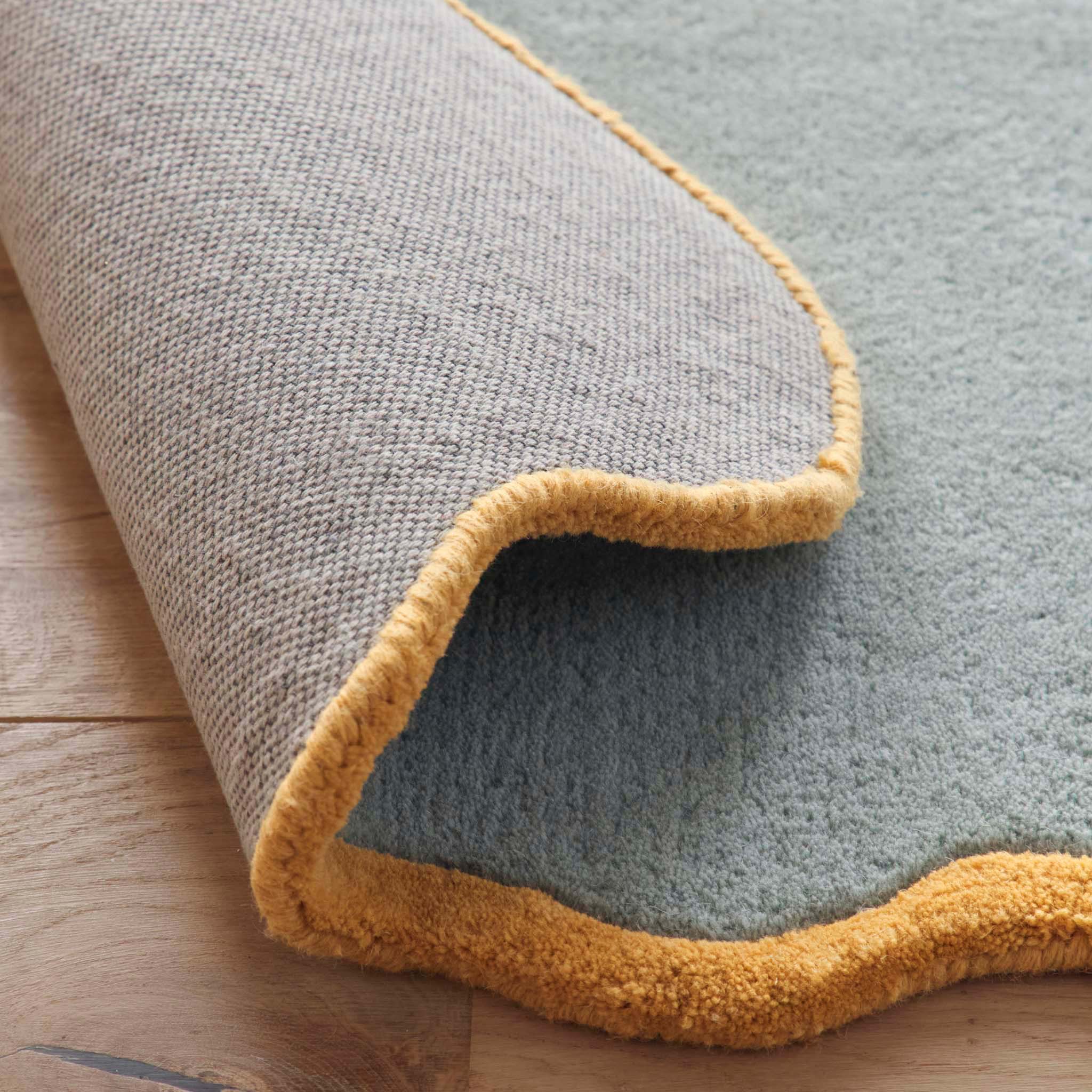 Scalloped Elise Duck Egg Ochre Runner - a 100% wool blue runner featuring a scalloped yellow border. 