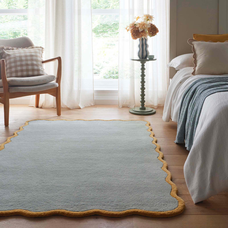 Scalloped Elise Duck Egg Ochre Rug - a 100% wool blue rug featuring a scalloped yellow border. 