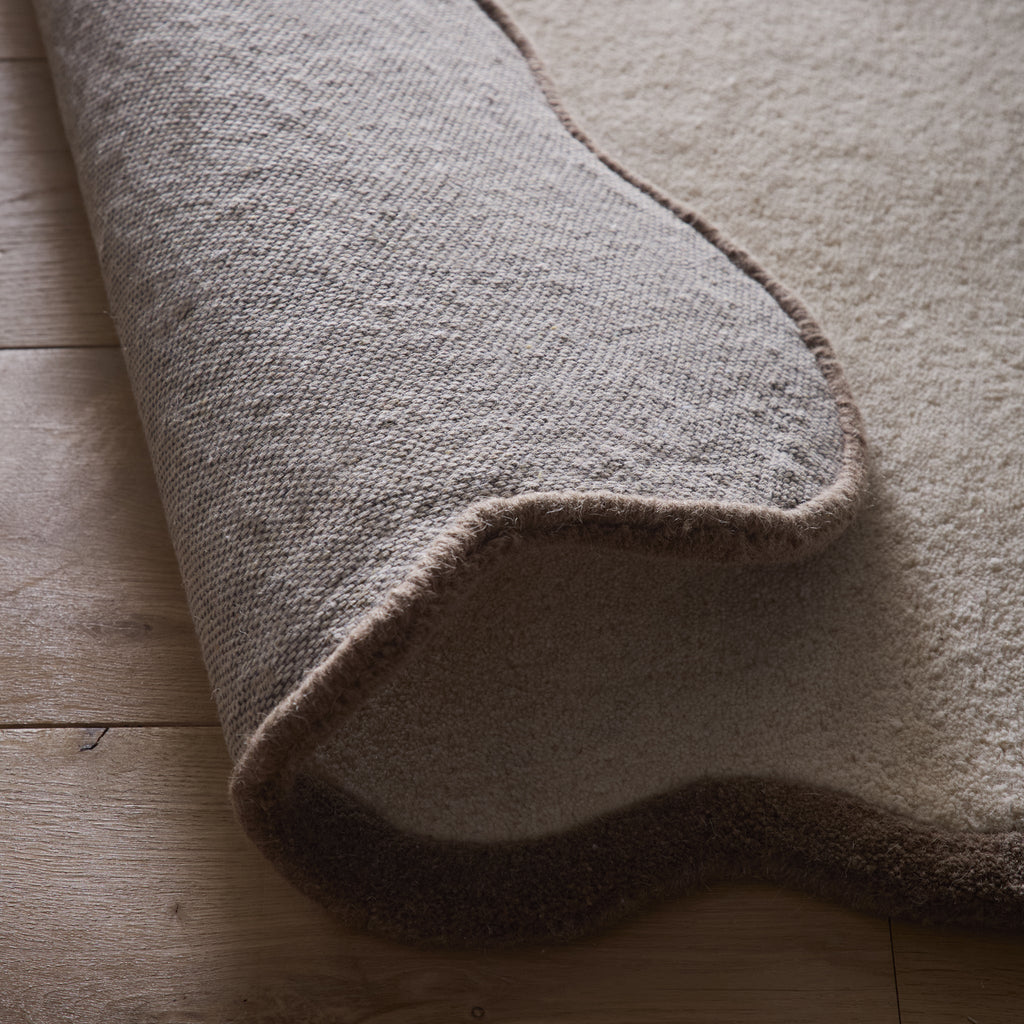 Scalloped Elise Rug in Natural and Brown- a 100% wool cut, loop pile rug with a wavy  border. 