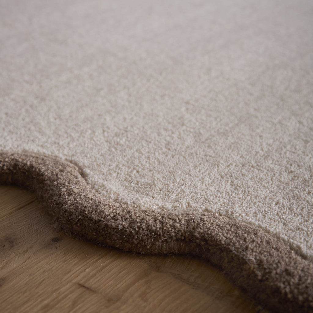 Scalloped Elise Rug in Natural and Brown- a 100% wool cut, loop pile rug with a wavy  border. 