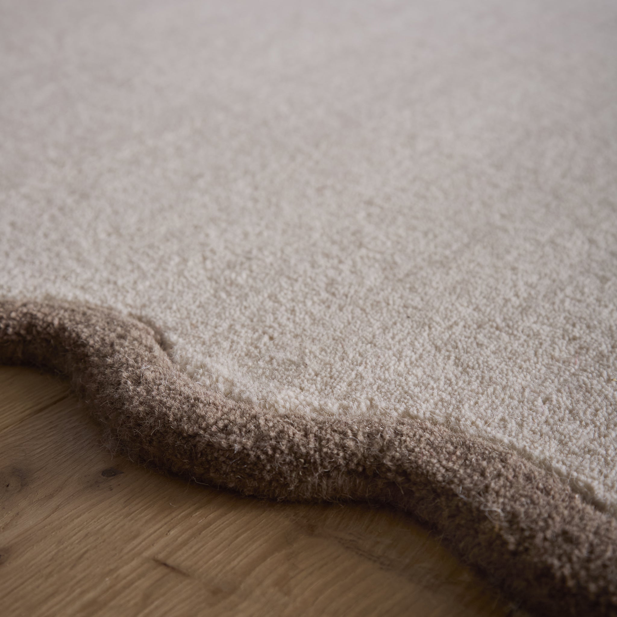 Scalloped Elise Rug in Natural and Brown- a 100% wool cut, loop pile rug with a wavy  border. 