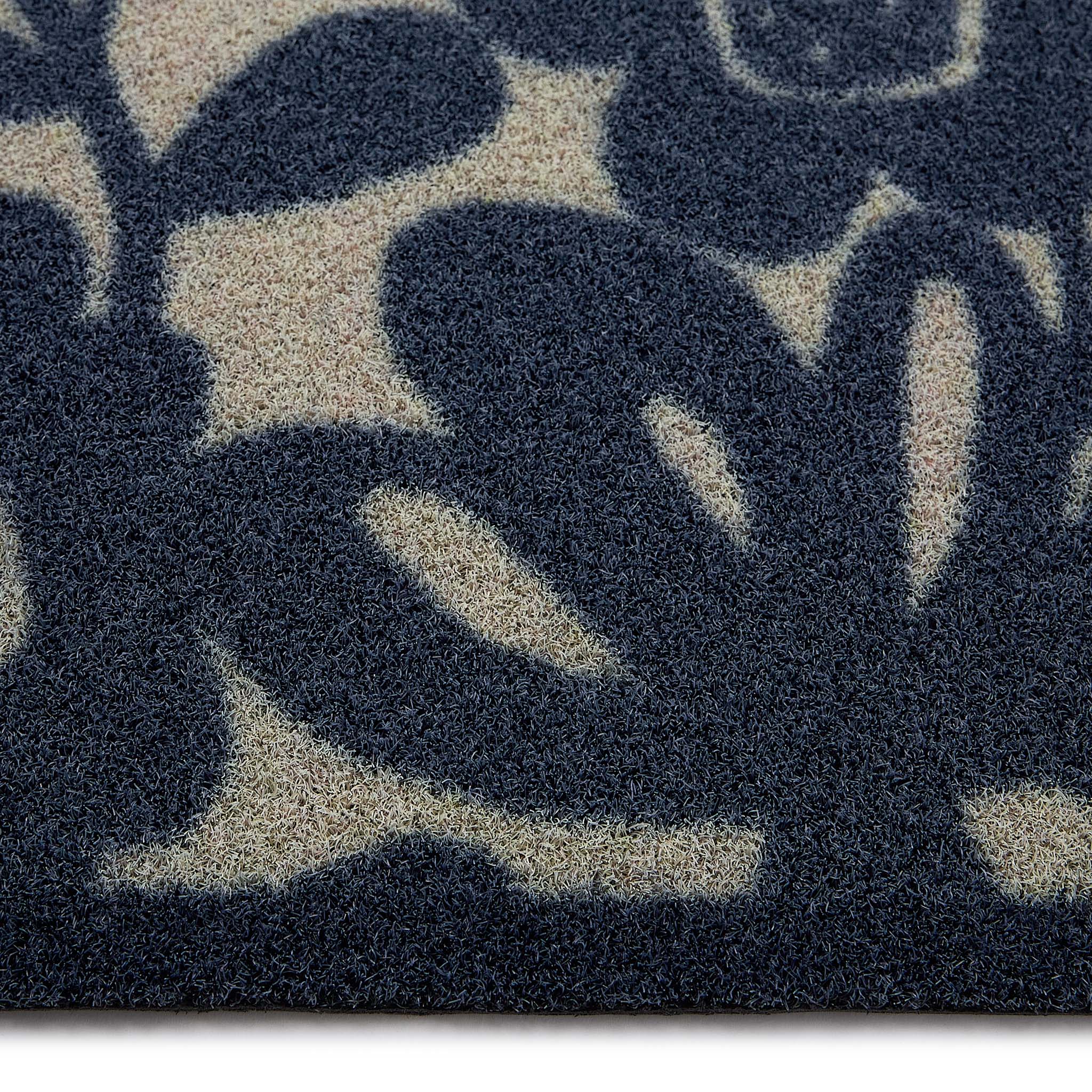 Kukkia Dark Navy Outdoor Doormat with a floral design, styled with pile height showing.