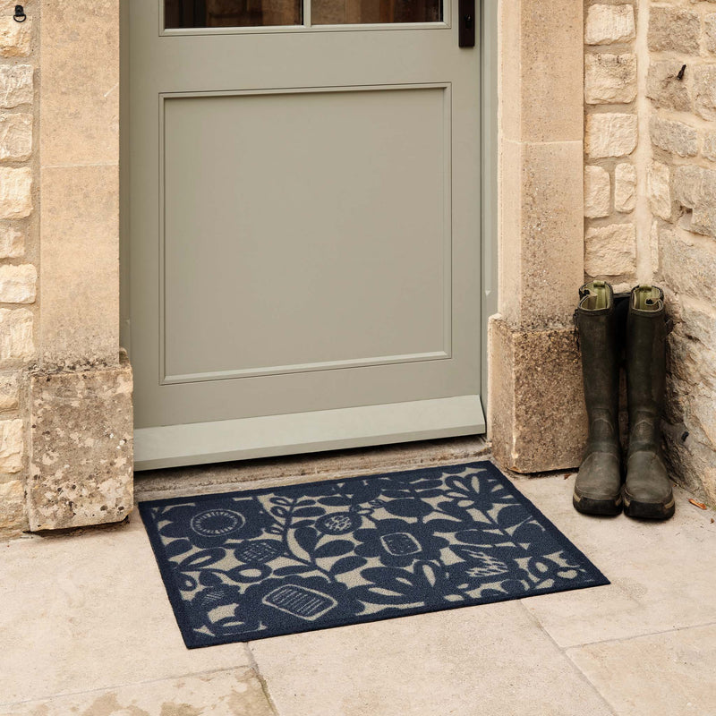 Kukkia Dark Navy Outdoor Doormat. Made from ECONYL regenerated yarn featuring a navy floral pattern.