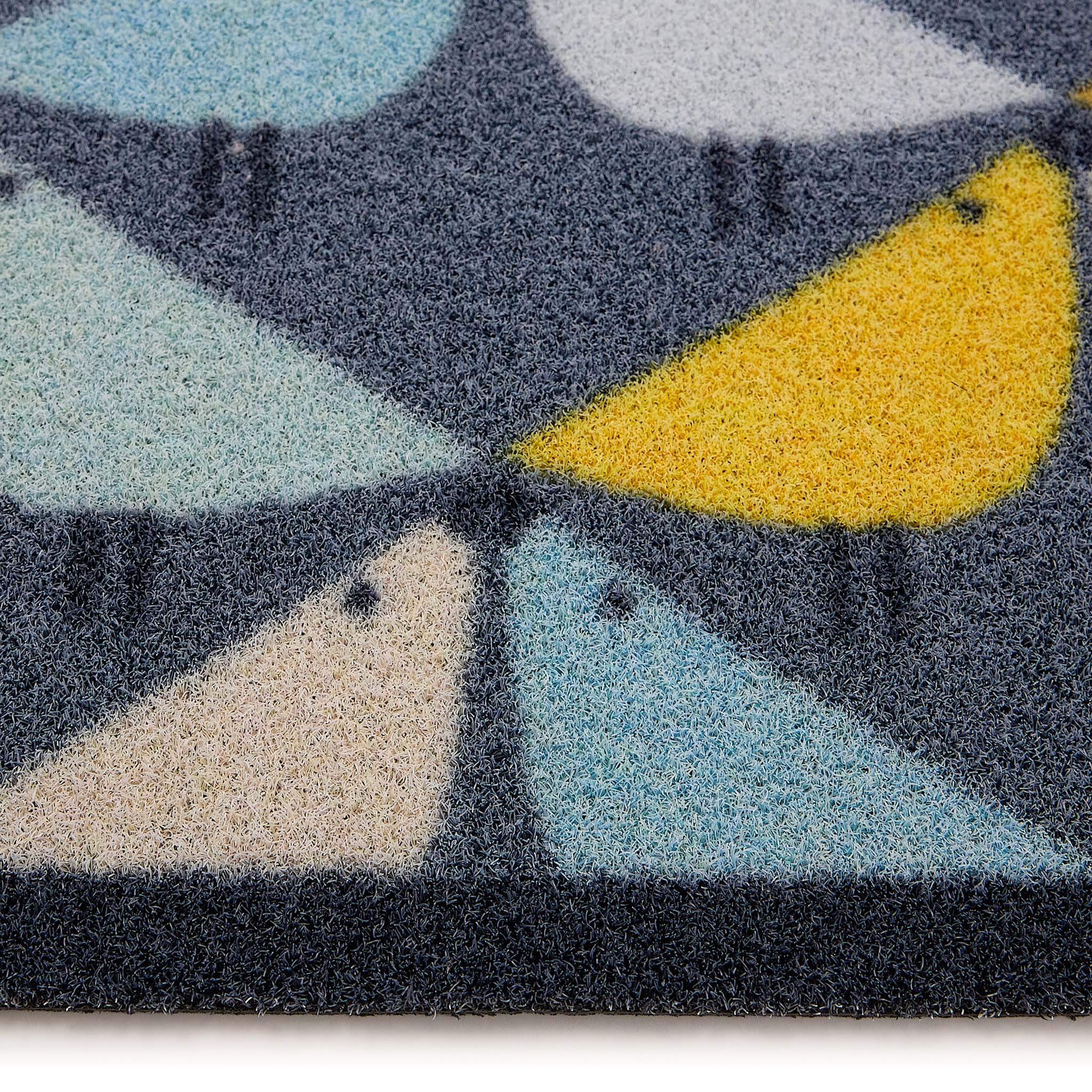 Scion Lintu Blue Outdoor Doormat with a lintu bird design, styled with pile height showing.