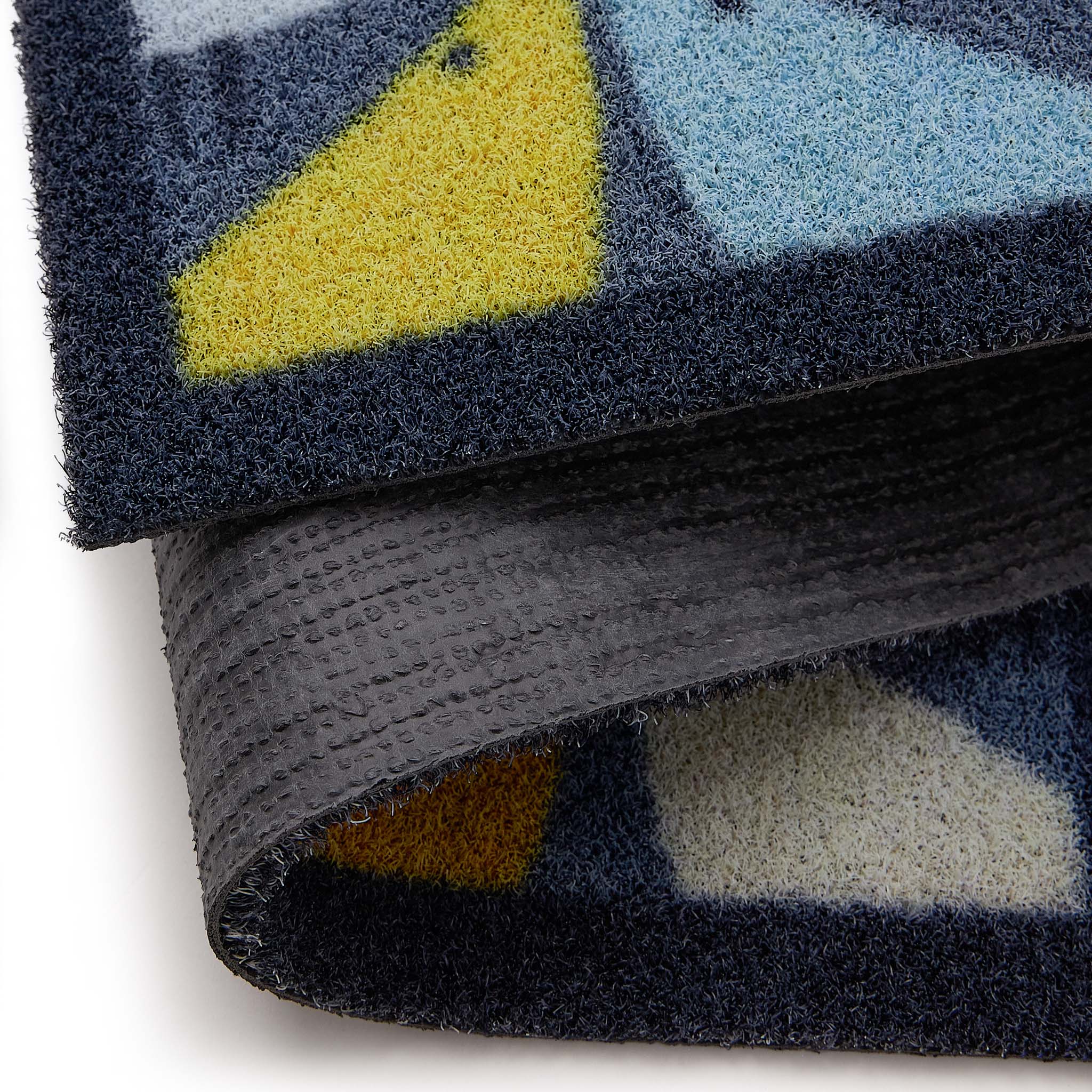 Scion Lintu Blue Outdoor Doormat with a lintu bird design, styled with backing showing.