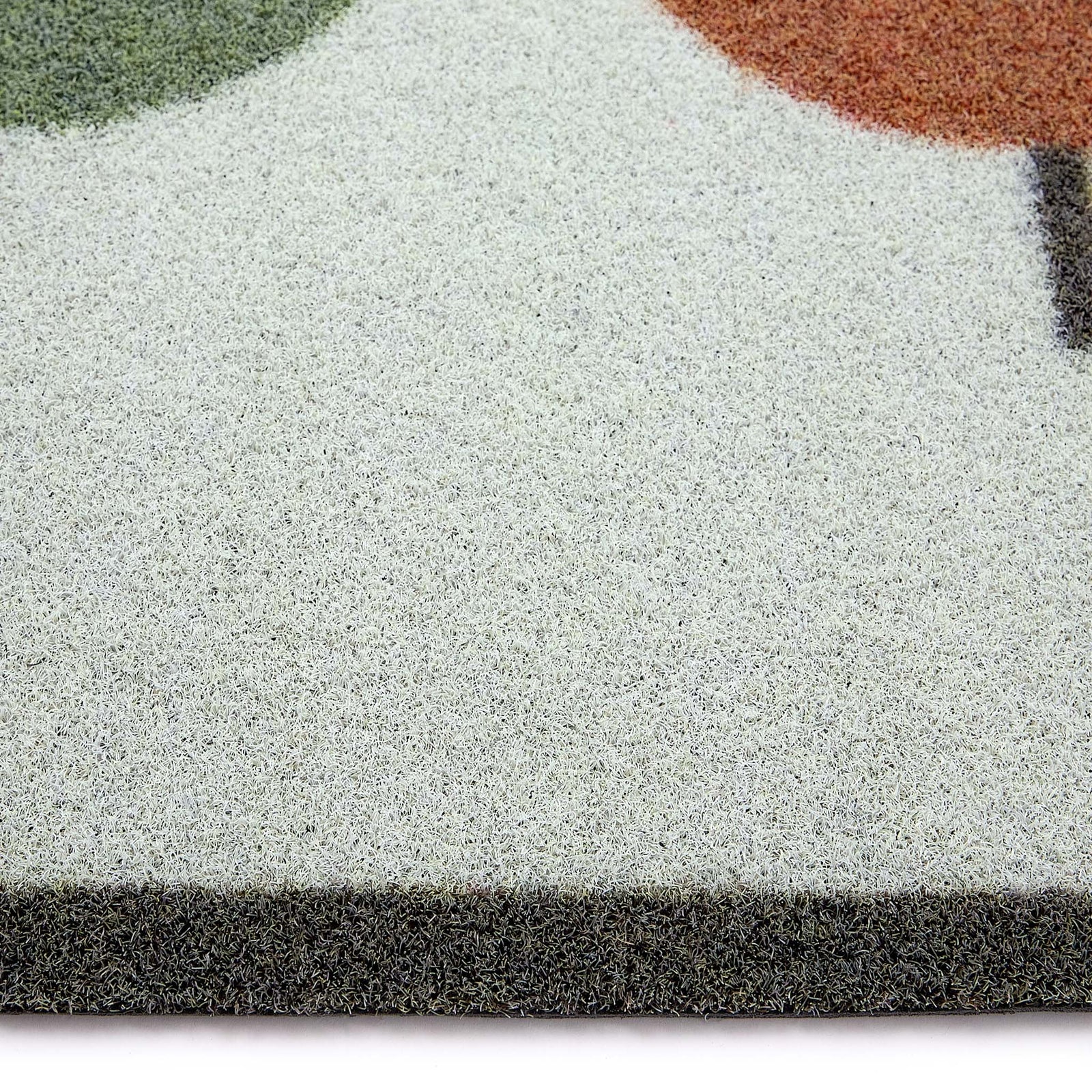 Scion Lintu Rust Green Outdoor Doormat with a lintu bird design, styled with pile height showing.
