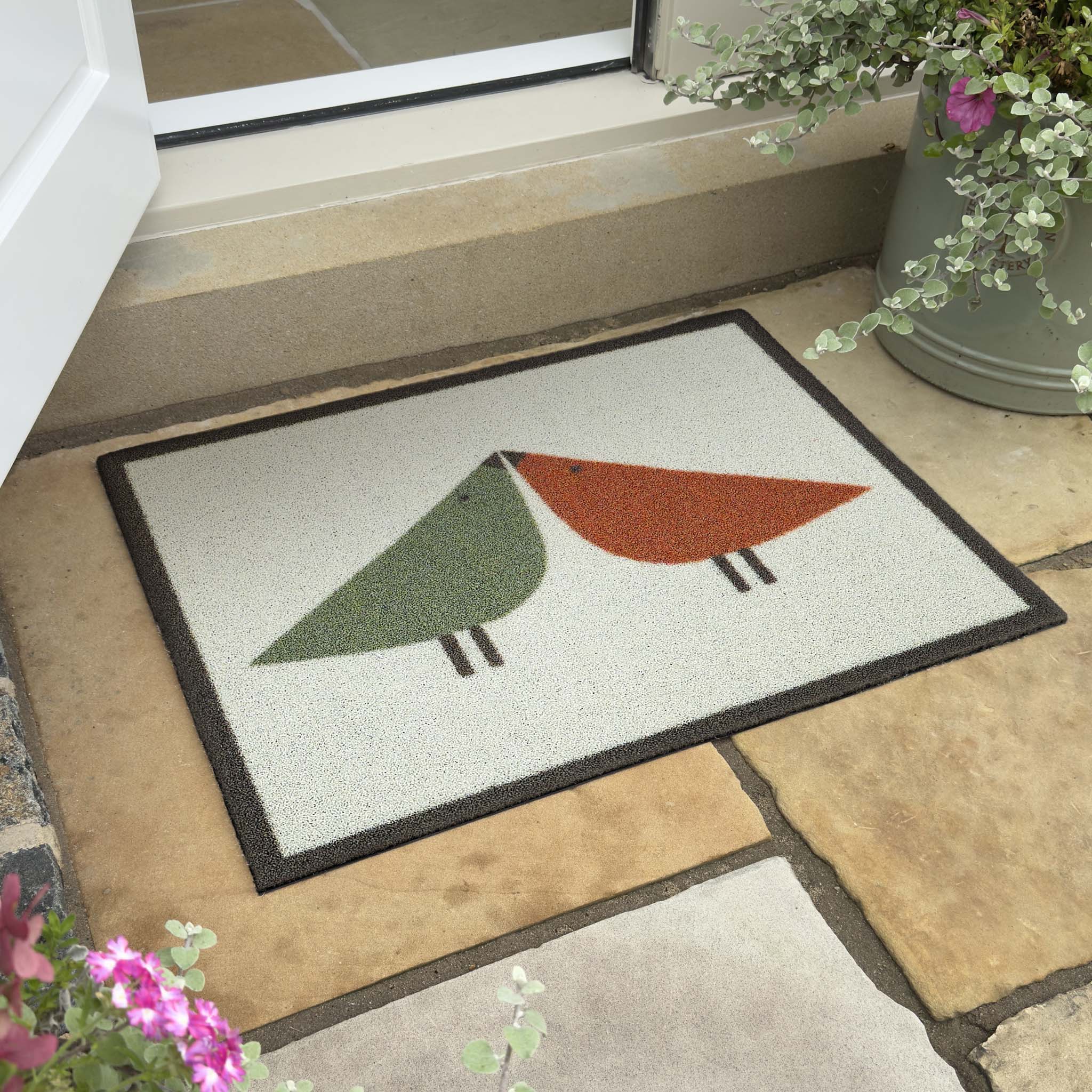Lintu Rust/Green Outdoor Doormat. Made from Econyl regenerated yarn featuring two Lintu Birds.