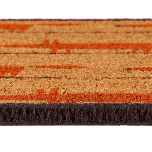 Close-up of a textured doormat with a natural coir background, rust-orange fox pattern, and dark brown fringe along the bottom edge.