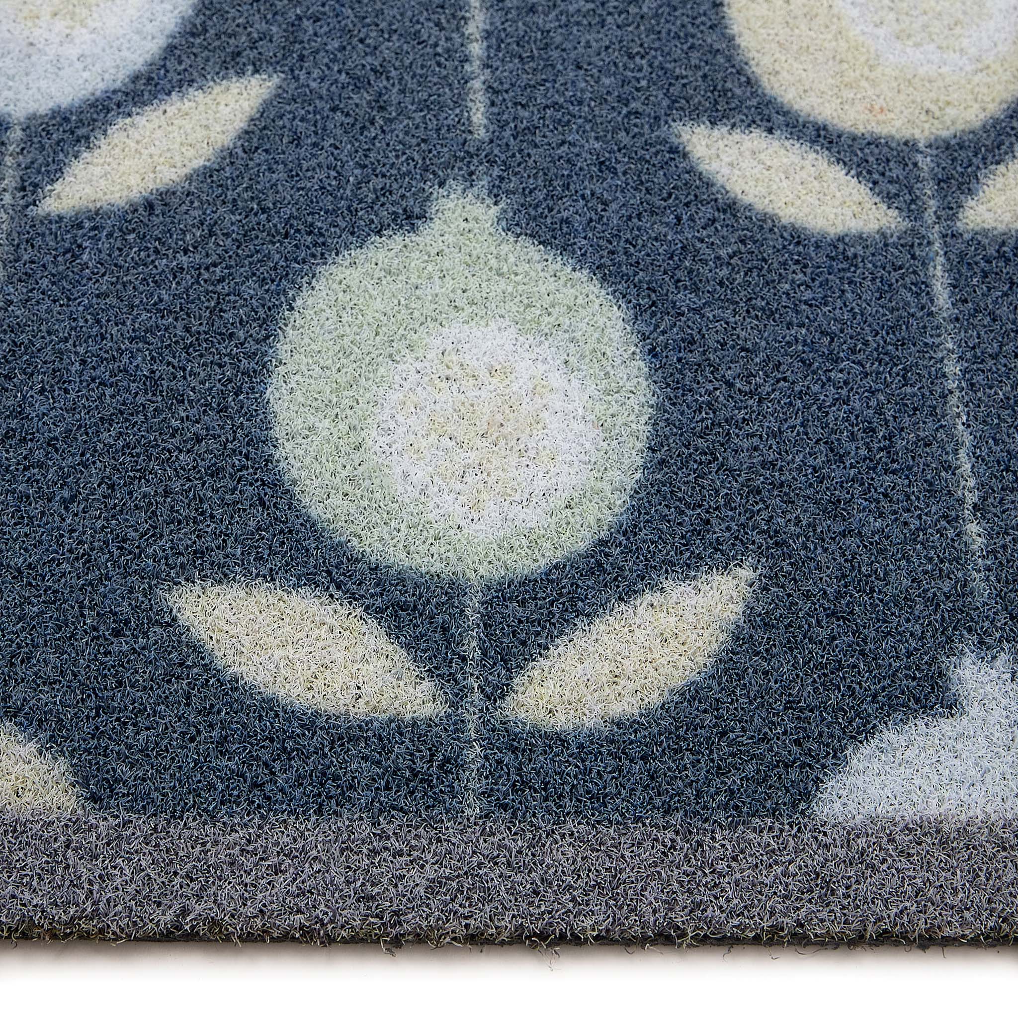 Scion Pepino Blue Outdoor Doormat with a floral design, styled with pile height showing.