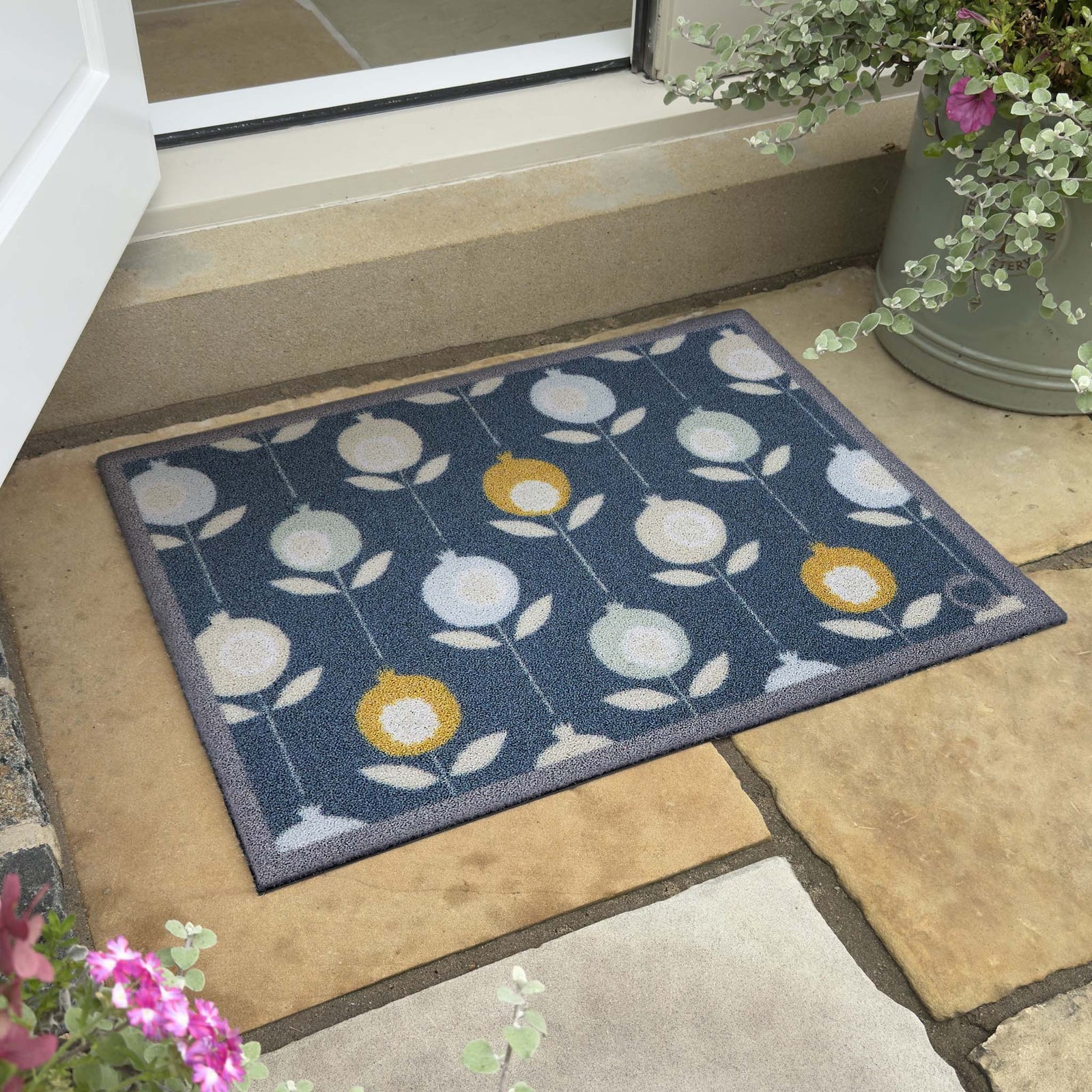 Pepino Blue Outdoor Doormat. Made from ECONYL regenerated yearn featurning a floral design.