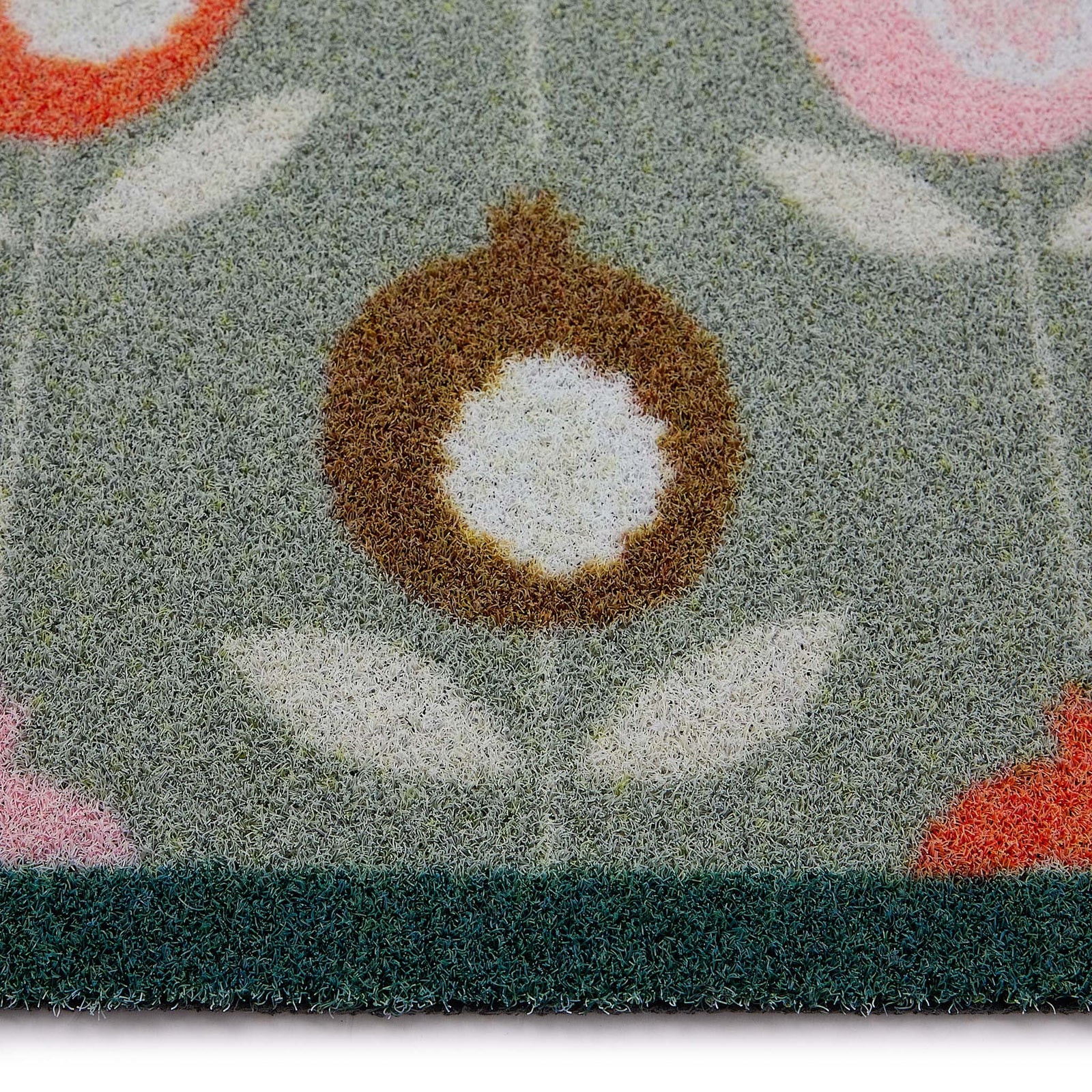 Scion Pepino Green Outdoor Doormat with a floral design, styled with pile height showing.