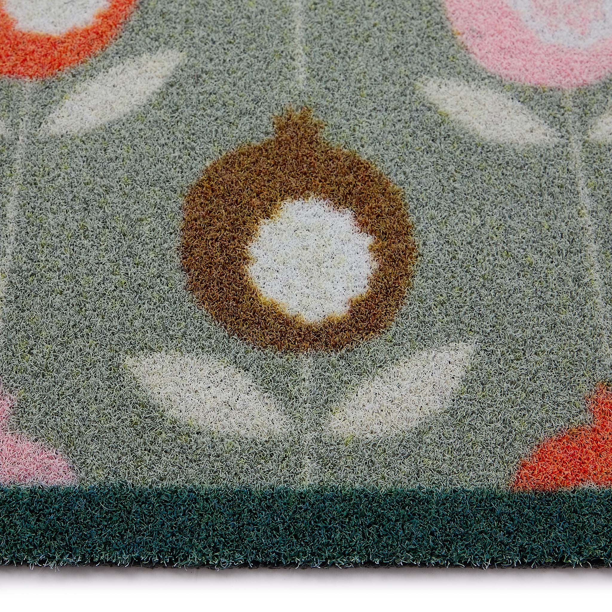 Scion Pepino Green Outdoor Doormat with a floral design, styled with pile height showing.