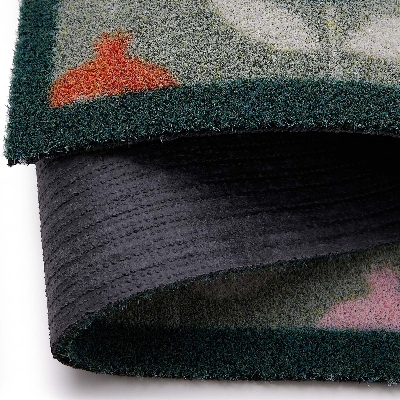 Scion Pepino Green Outdoor Doormat with a floral design, styled with backing showing.
