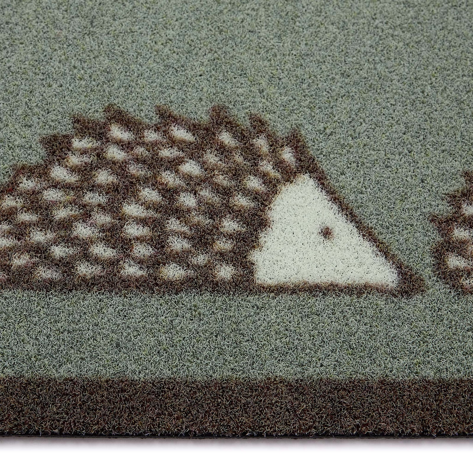 Scion Spike Green Outdoor Doormat with hedgehog design, styled with pile height showing.