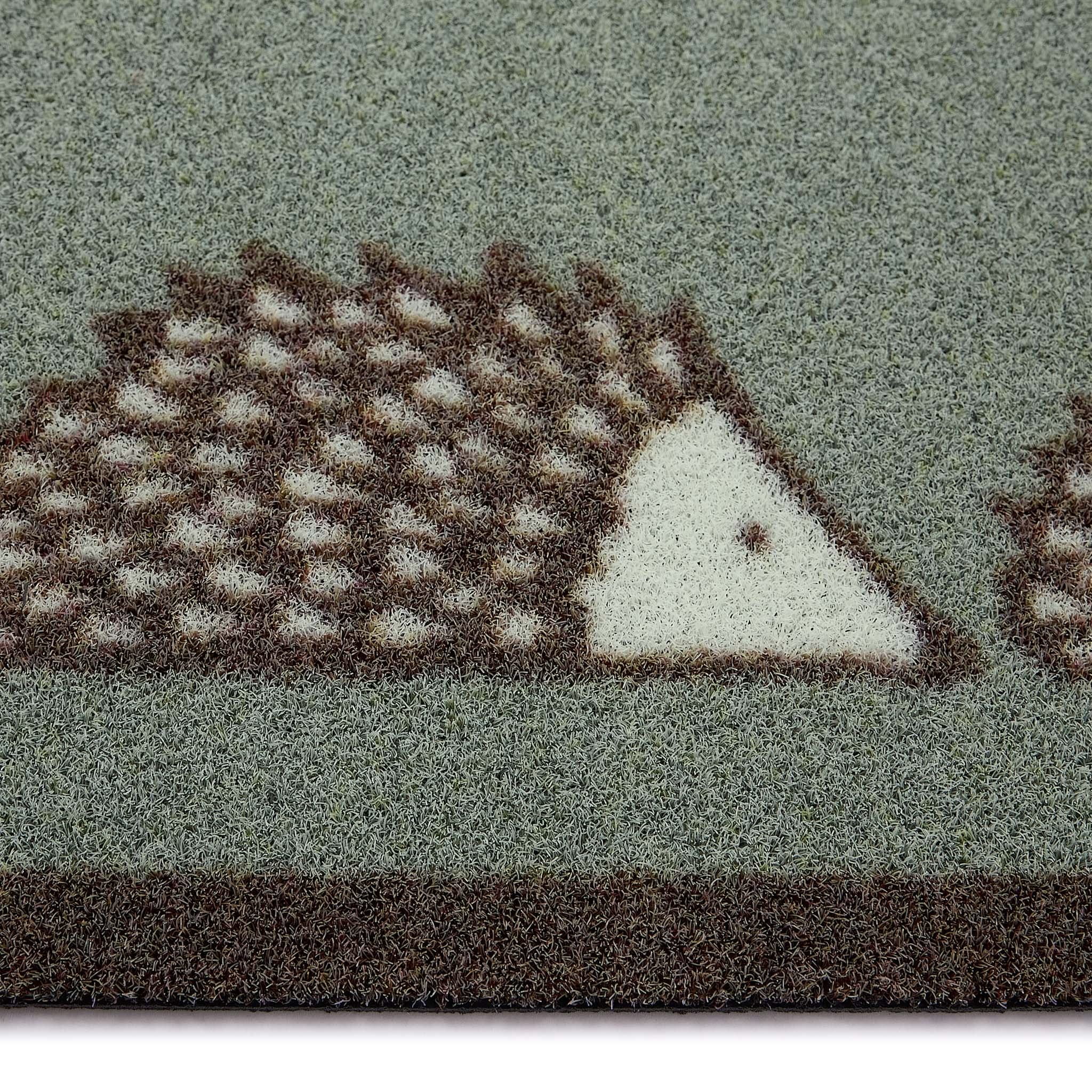 Scion Spike Green Outdoor Doormat with hedgehog design, styled with pile height showing.