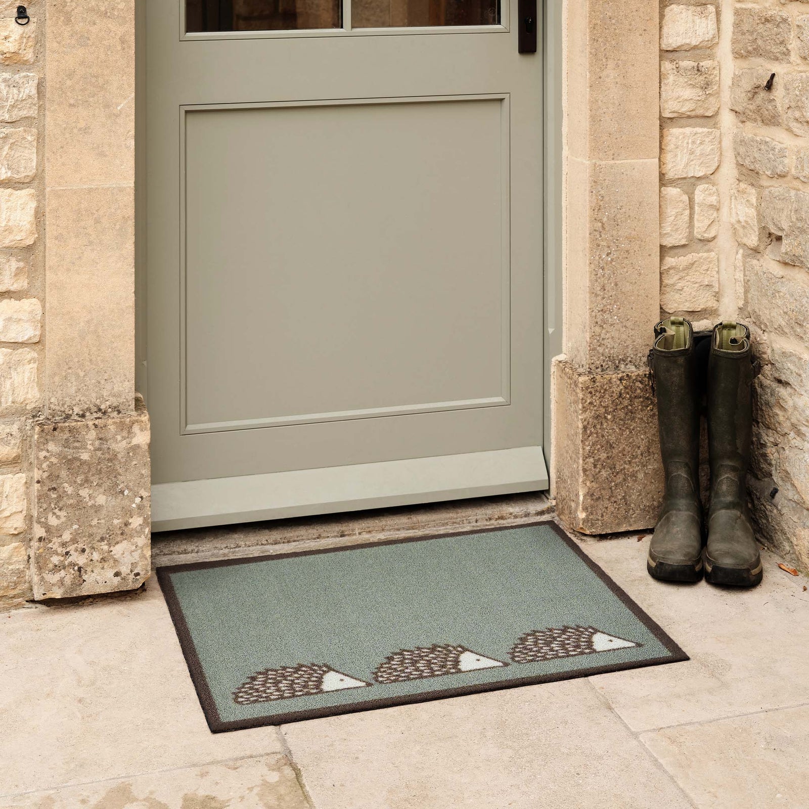 Spike Green Outdoor Doormat. Made from ECONYL regenerated yarn featuring three hedgehogs.