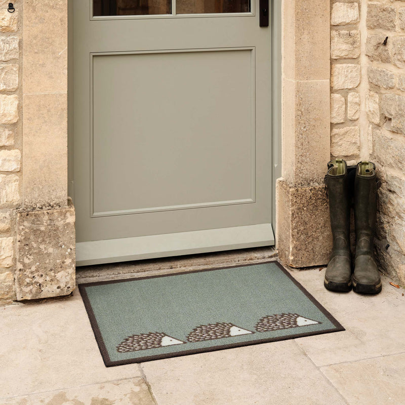Spike Green Outdoor Doormat. Made from ECONYL regenerated yarn featuring three hedgehogs.