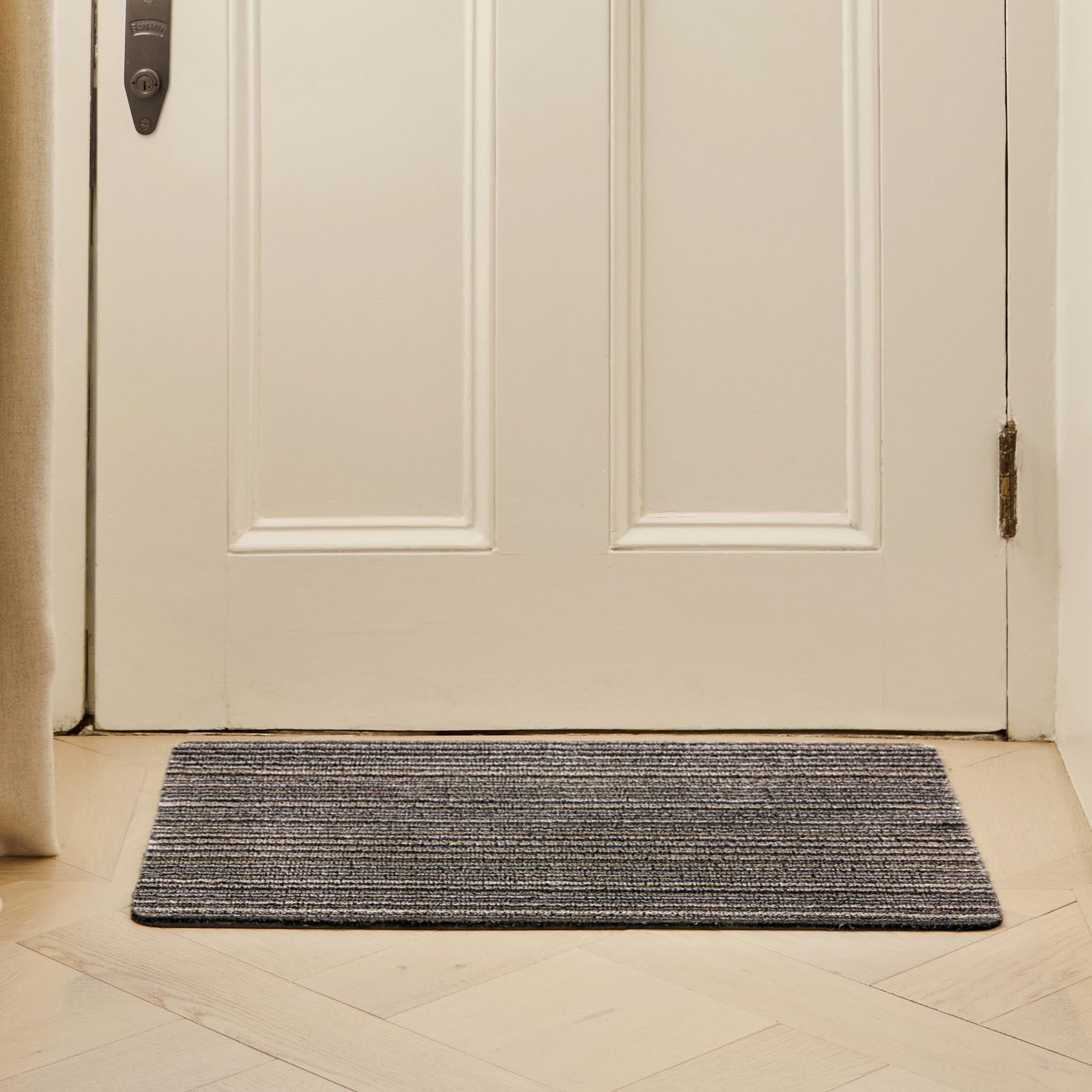 Select New England Stripe Doormat made from 100% recycled materials, featuring a subtle striped pattern. 