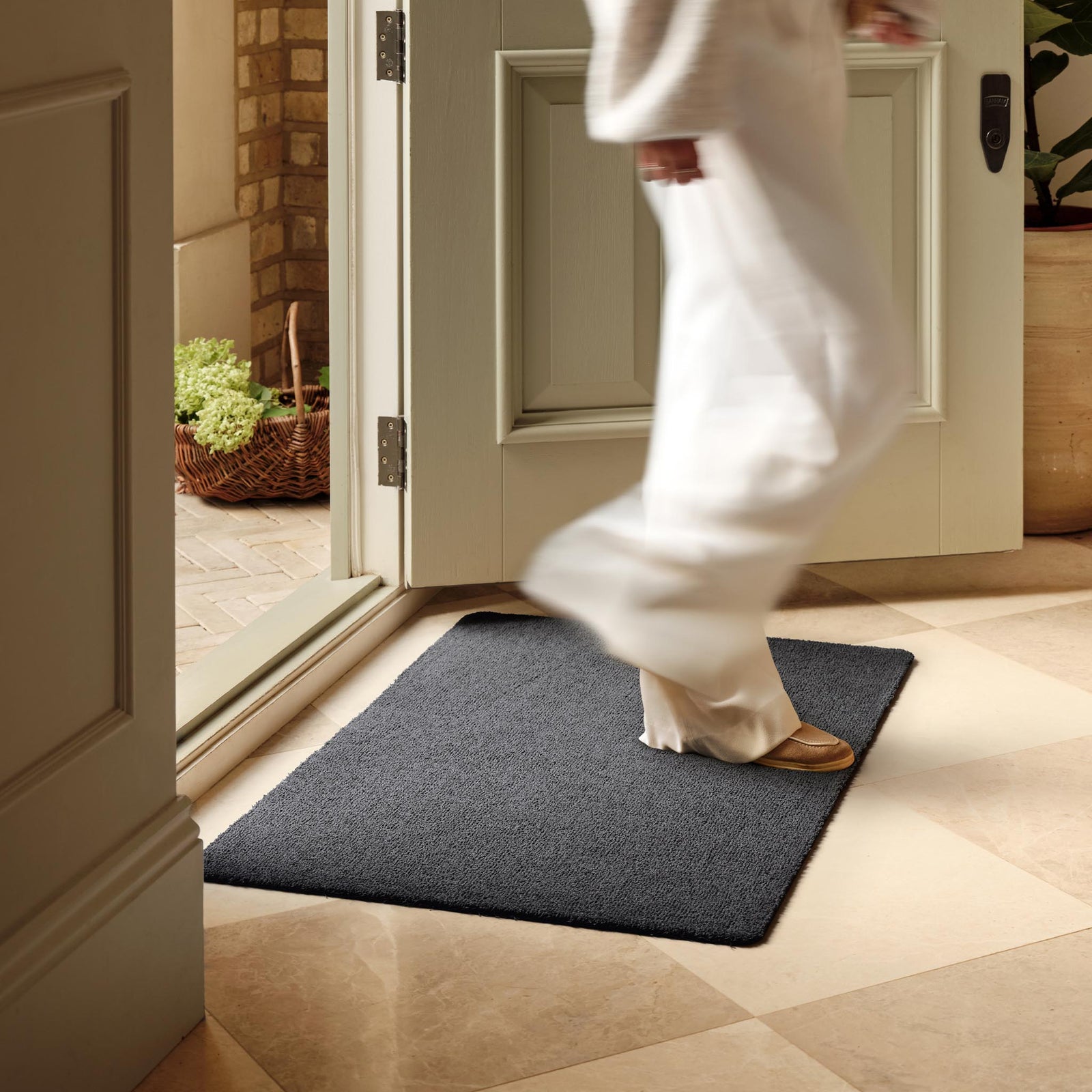Sense Charcoal Washable Doormat in a solid dark grey colour, styled in a doorway.