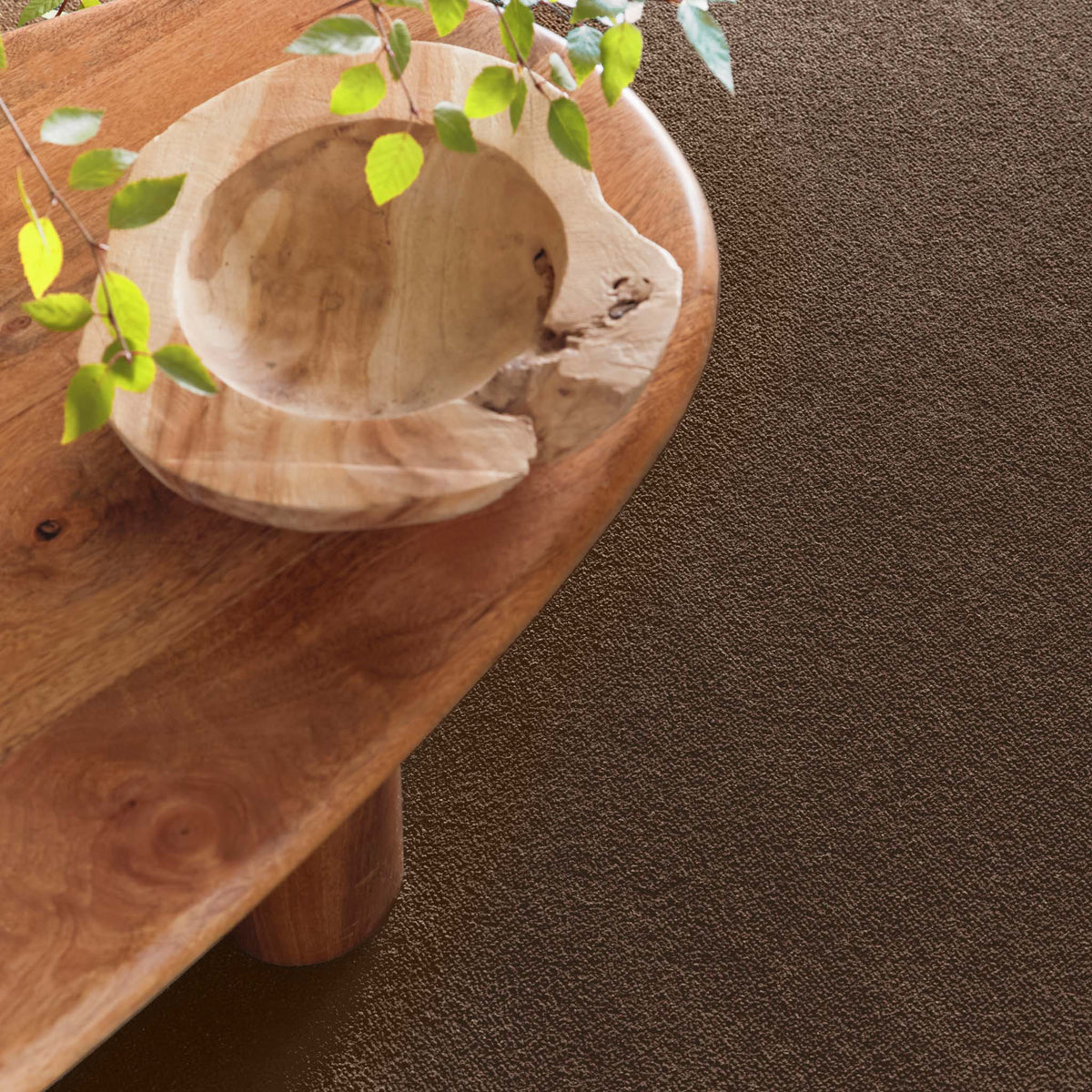 Sense Stone Washable Rug in Brown, styled under a wooden table.