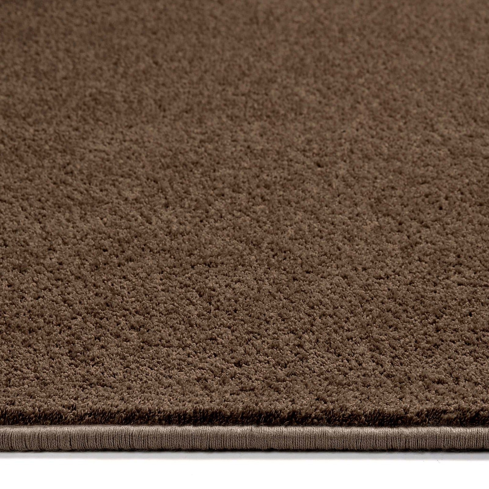 Sense Stone Washable Rug in Brown made from recycled materials, styled with pile height showing.