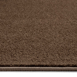 Sense Stone Washable Rug in Brown made from recycled materials, styled with pile height showing.