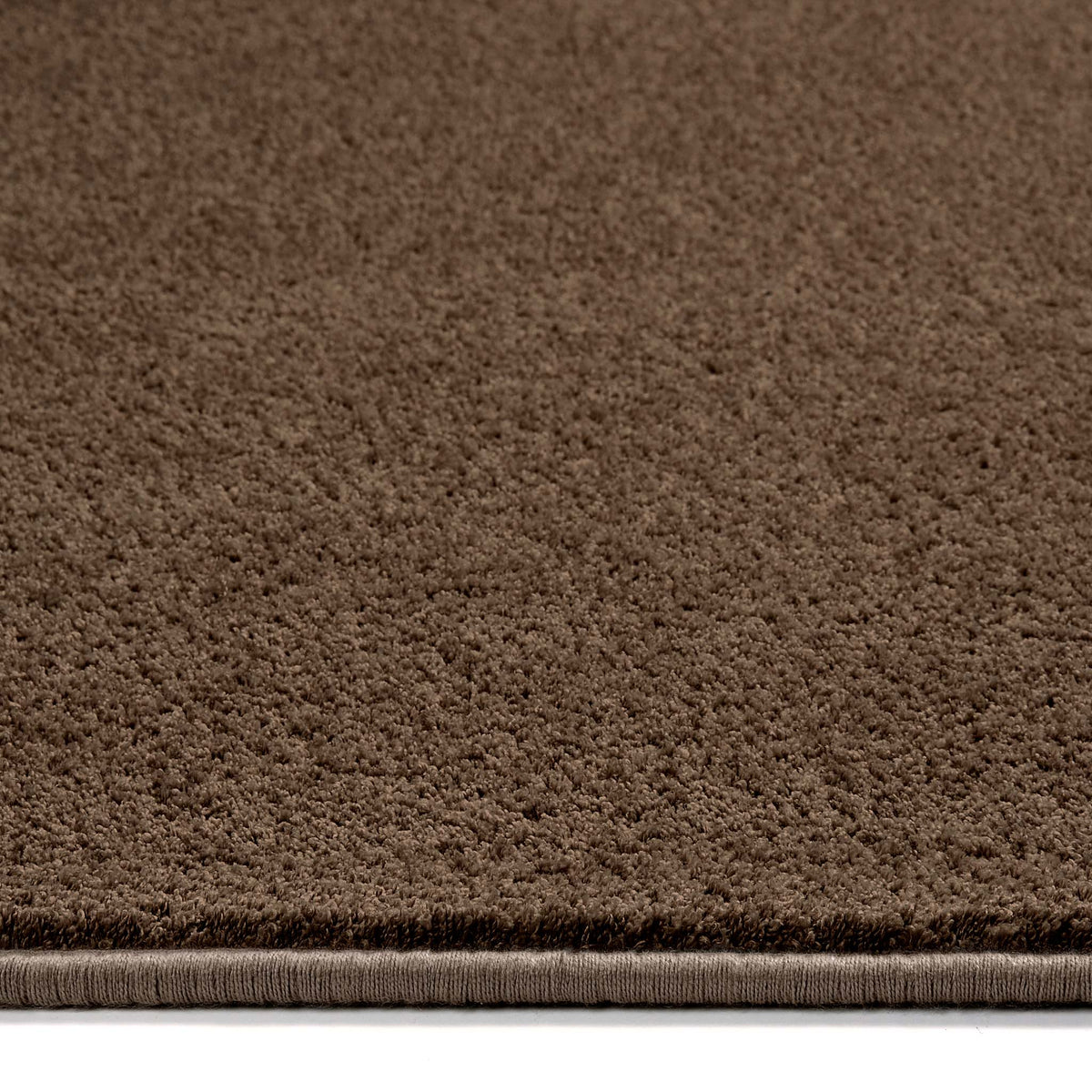 Sense Stone Washable Rug in Brown made from recycled materials, styled with pile height showing.