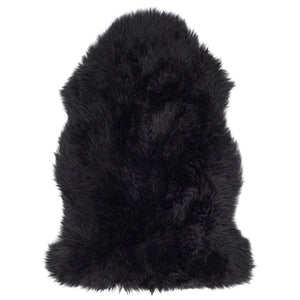 Single Sheepskin rug in black overhead on white background