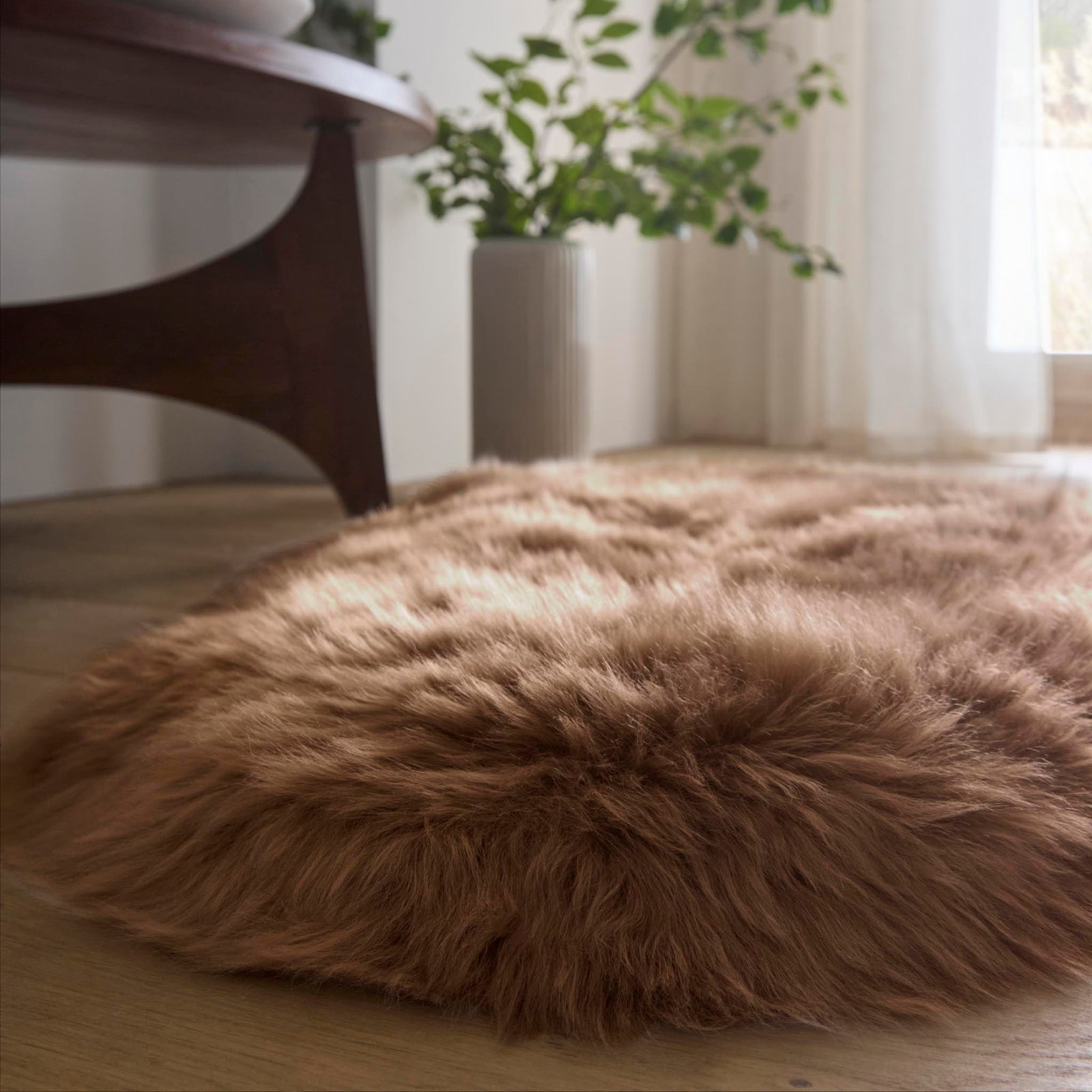 Close-up of Sheepskin Wool Mink Brown Rug showing pile height, styled on wooden flooring.