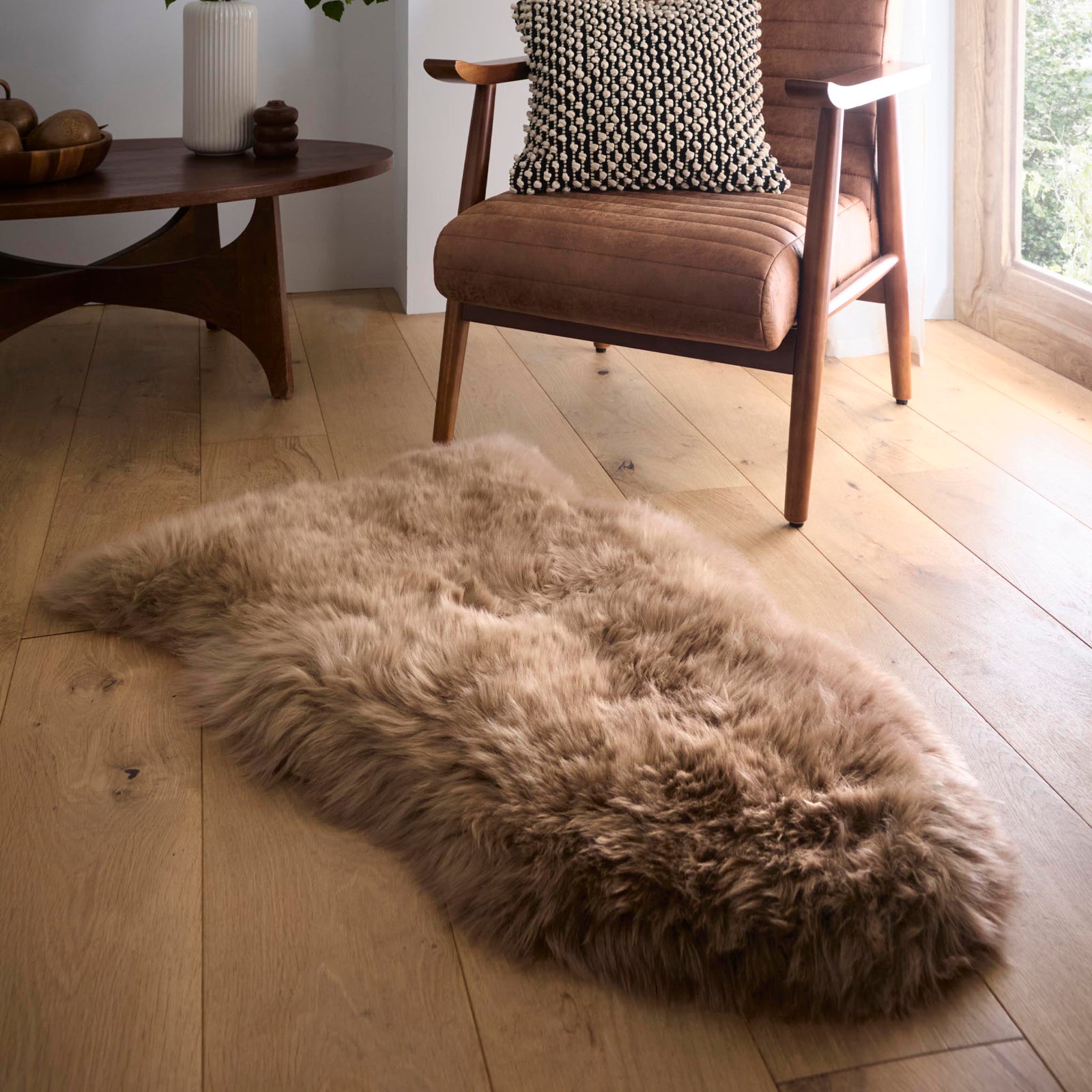 Single Sheepskin Mink Brown Wool Rug made from long-haired wool, styled on wooden flooring.