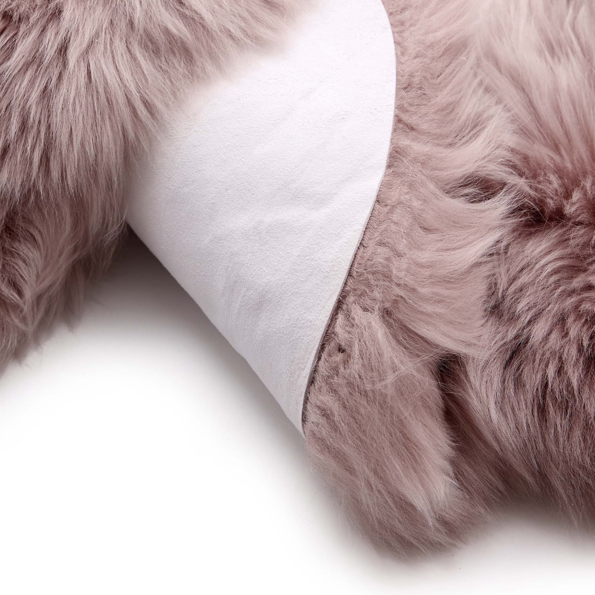 Close-up of Single Rose Pink Sheepskin Rug showing backing.