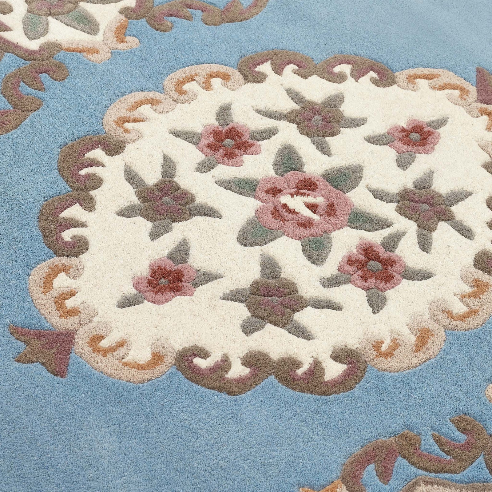 Shensi Blue Rug - a 100% wool rug featuring a traditional floral pattern.