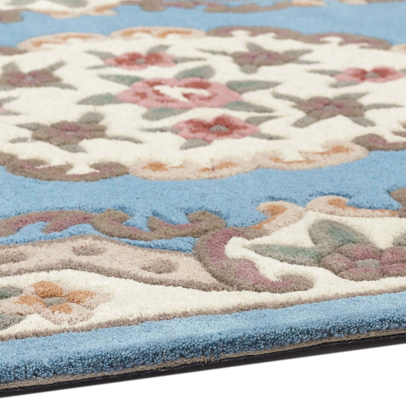 Shensi Blue Rug - a 100% wool rug featuring a traditional floral pattern.