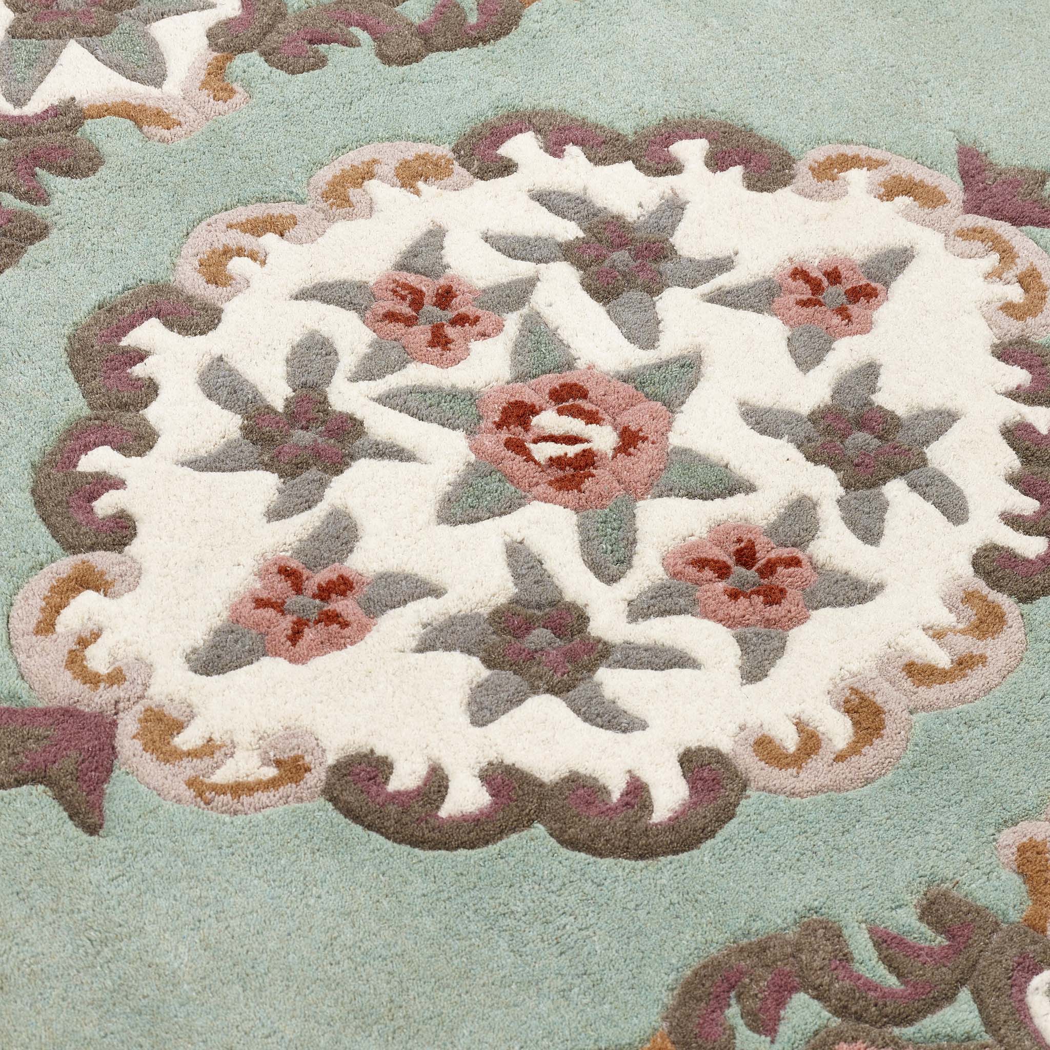 Shensi Green Rug - a 100% wool rug featuring a traditional floral pattern.