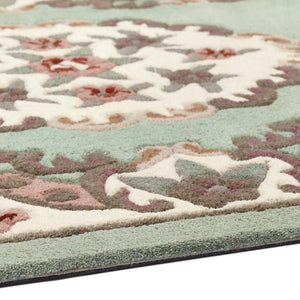 Shensi Green Rug - a 100% wool rug featuring a traditional floral pattern.