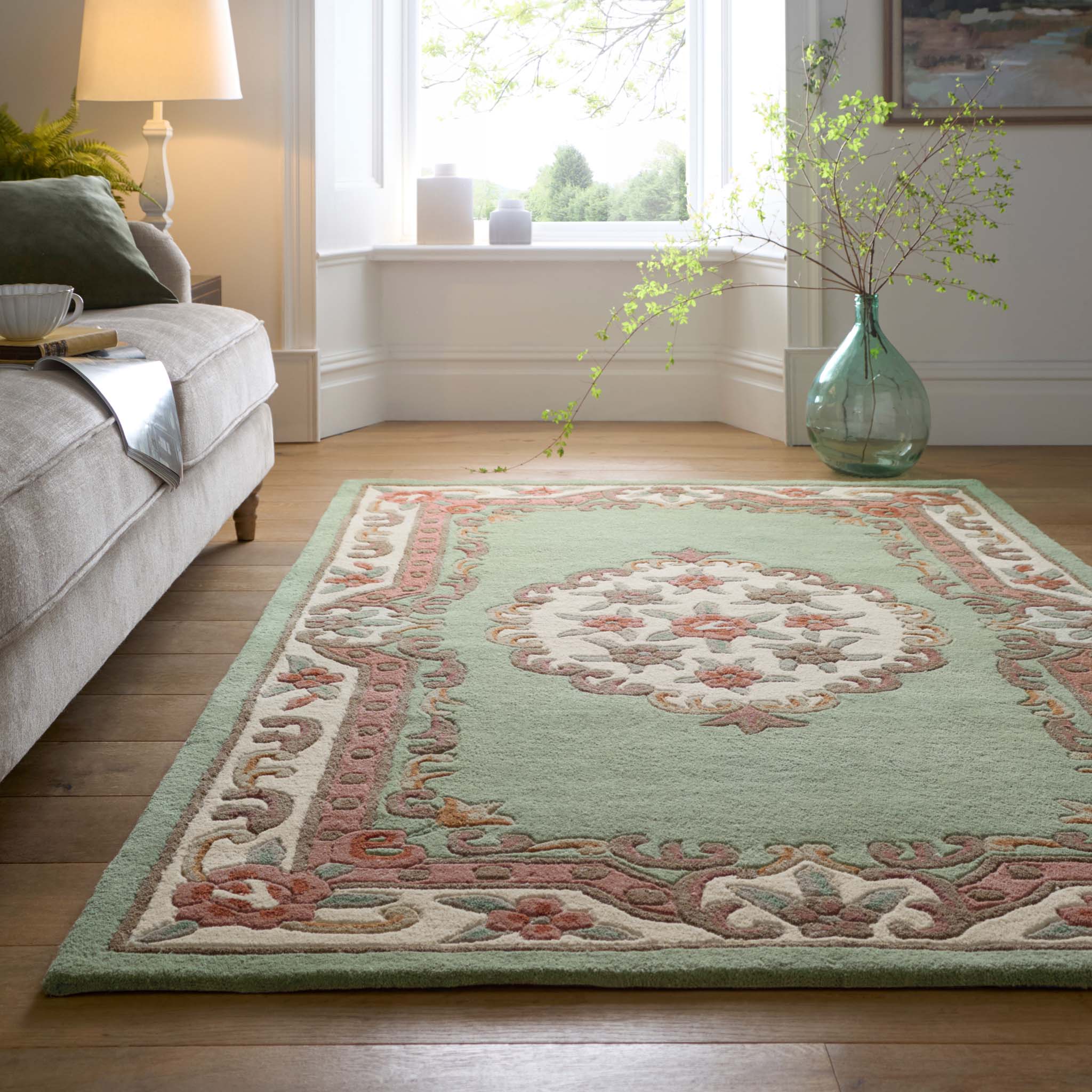 Shensi Green Rug - a 100% wool rug featuring a traditional floral pattern.