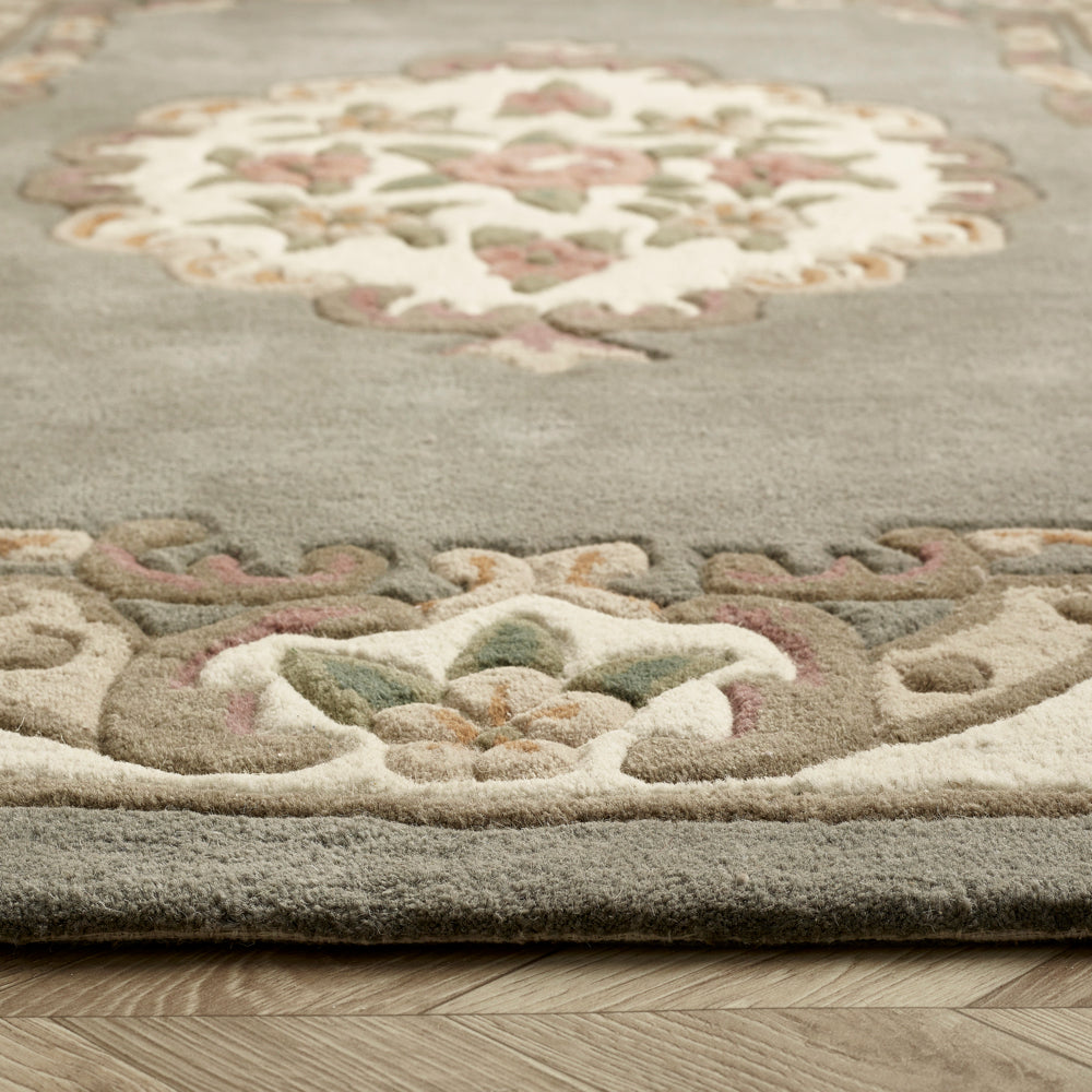 Shensi Aubusson Grey Rug made from 100% wool, featuring an ornate design. 