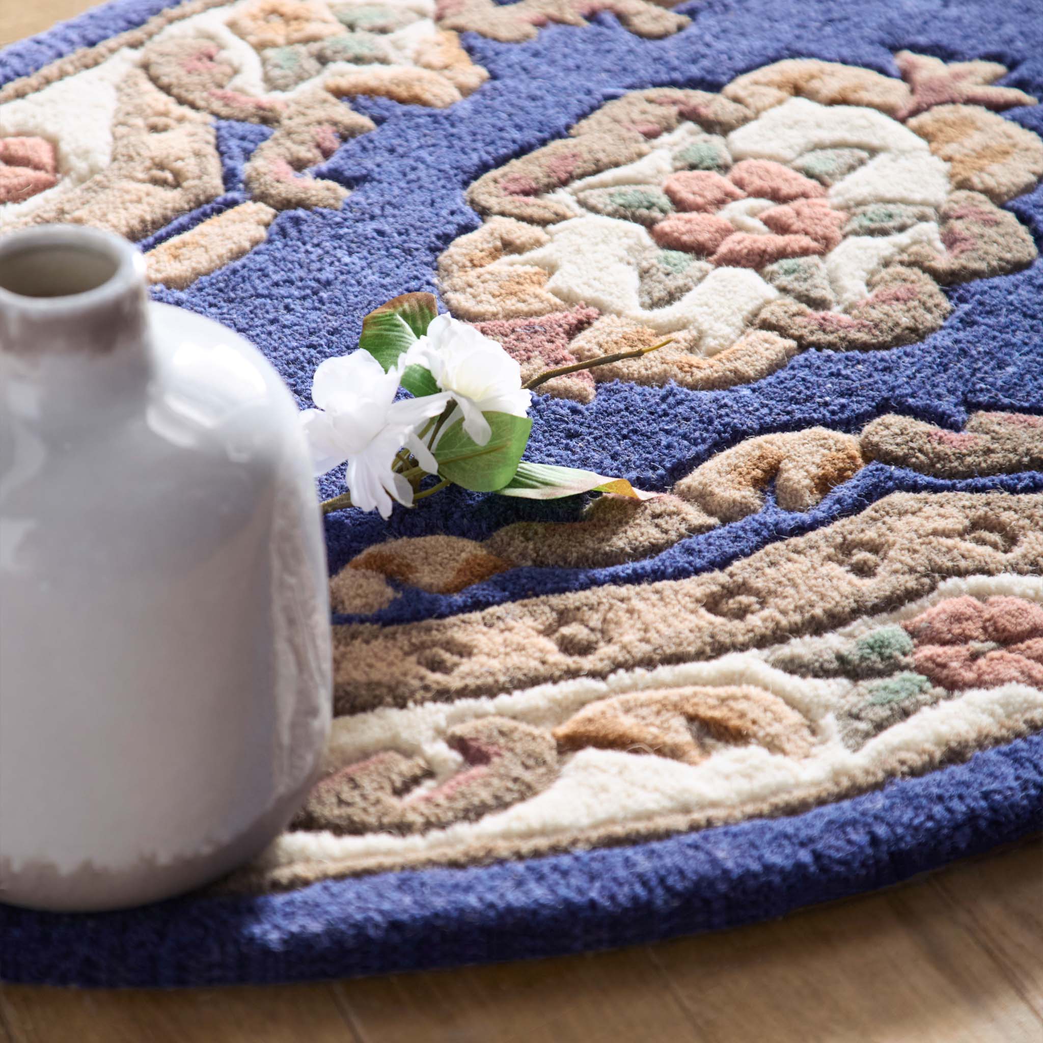 Shensi Navy Blue Wool Rug with a traditional floral pattern, styled on wooden flooring.