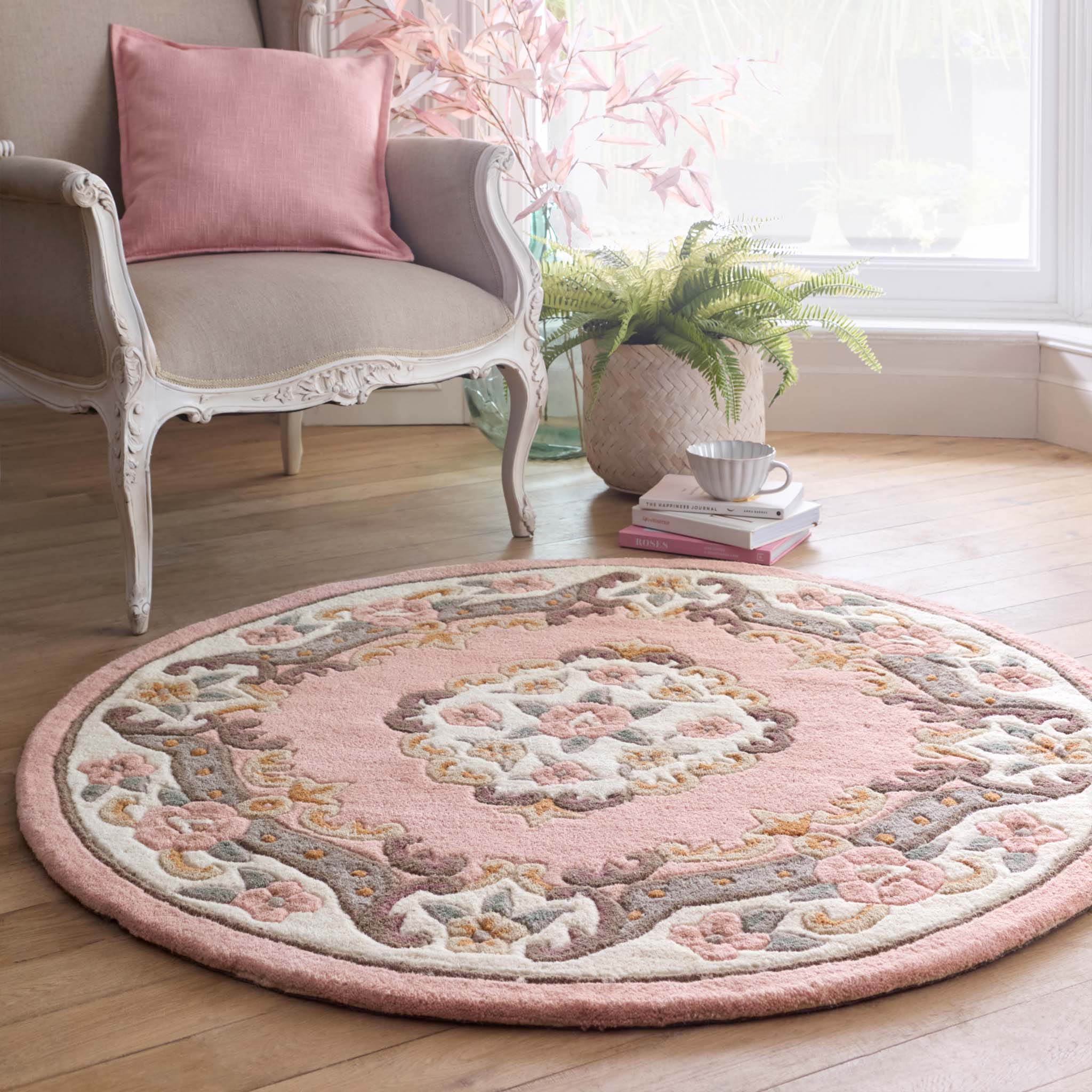 Shensi Pink Wool Rug with a traditional floral pattern, styled in a living room.