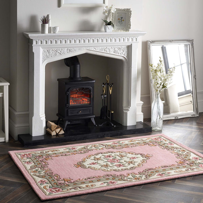 Shensi Pink Wool Rug with a traditional floral pattern, styled in a living room.