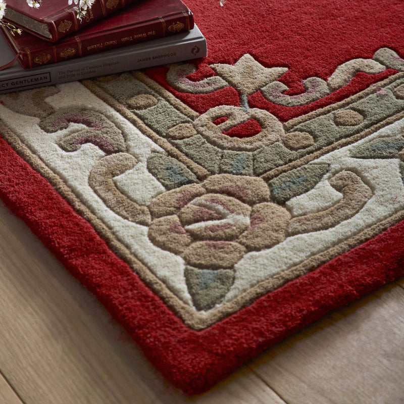 Shensi Wine Red Wool Rug with a traditional floral pattern, styled on wooden flooring.