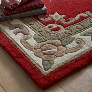 Shensi Wine Red Wool Rug with a traditional floral pattern, styled on wooden flooring.