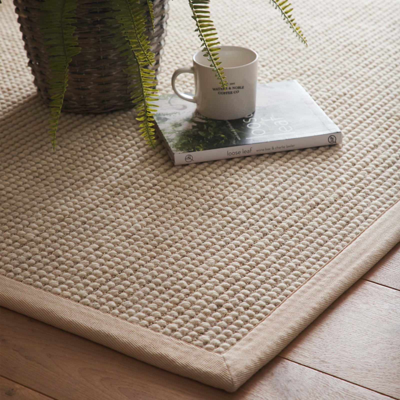 Sisal Boucle Beige Rug made from 100% wool with a beige border.